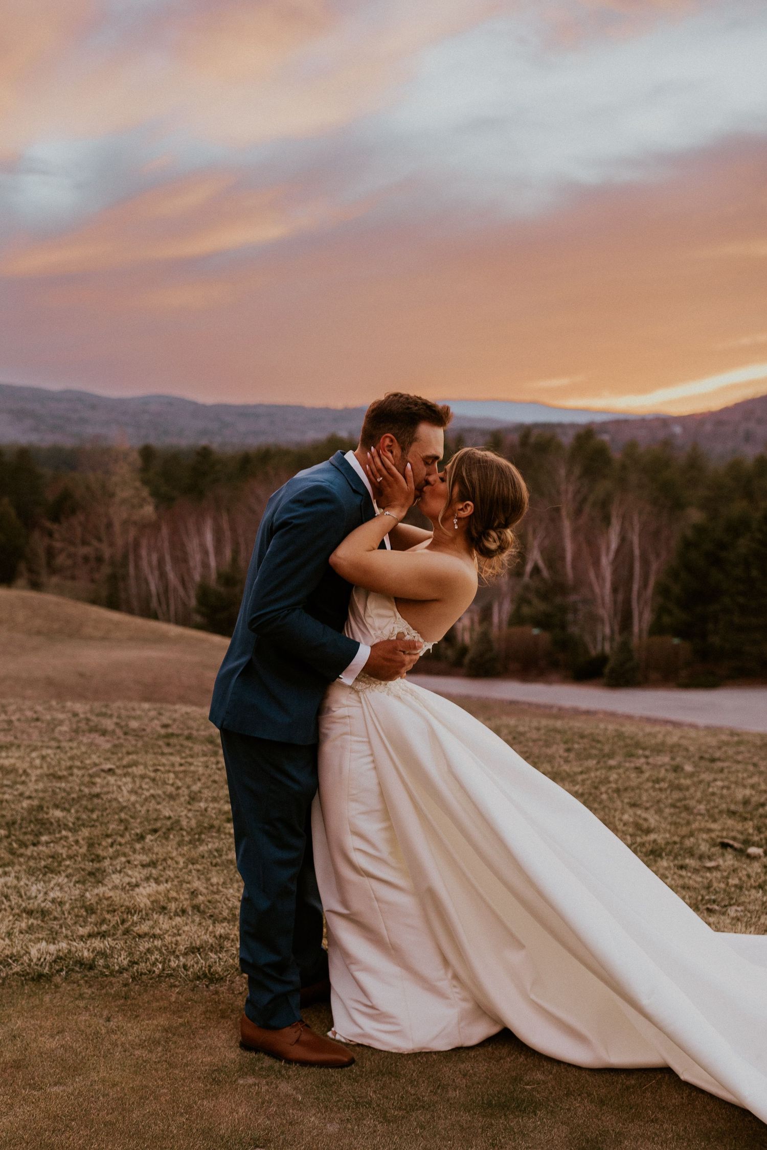 Kendra and Andrew kissing intimately during sunset at their Owl's Nest Resort Wedding.