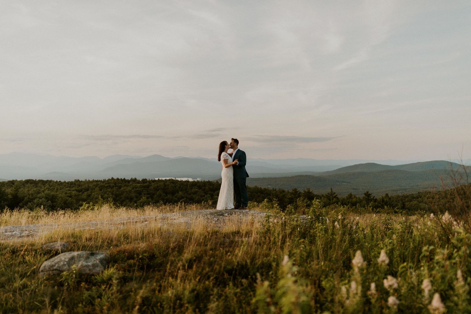 Danielle and Colin dressed in their wedding attire for their one year anniversary photoshoot on Foss Mountain in NH.