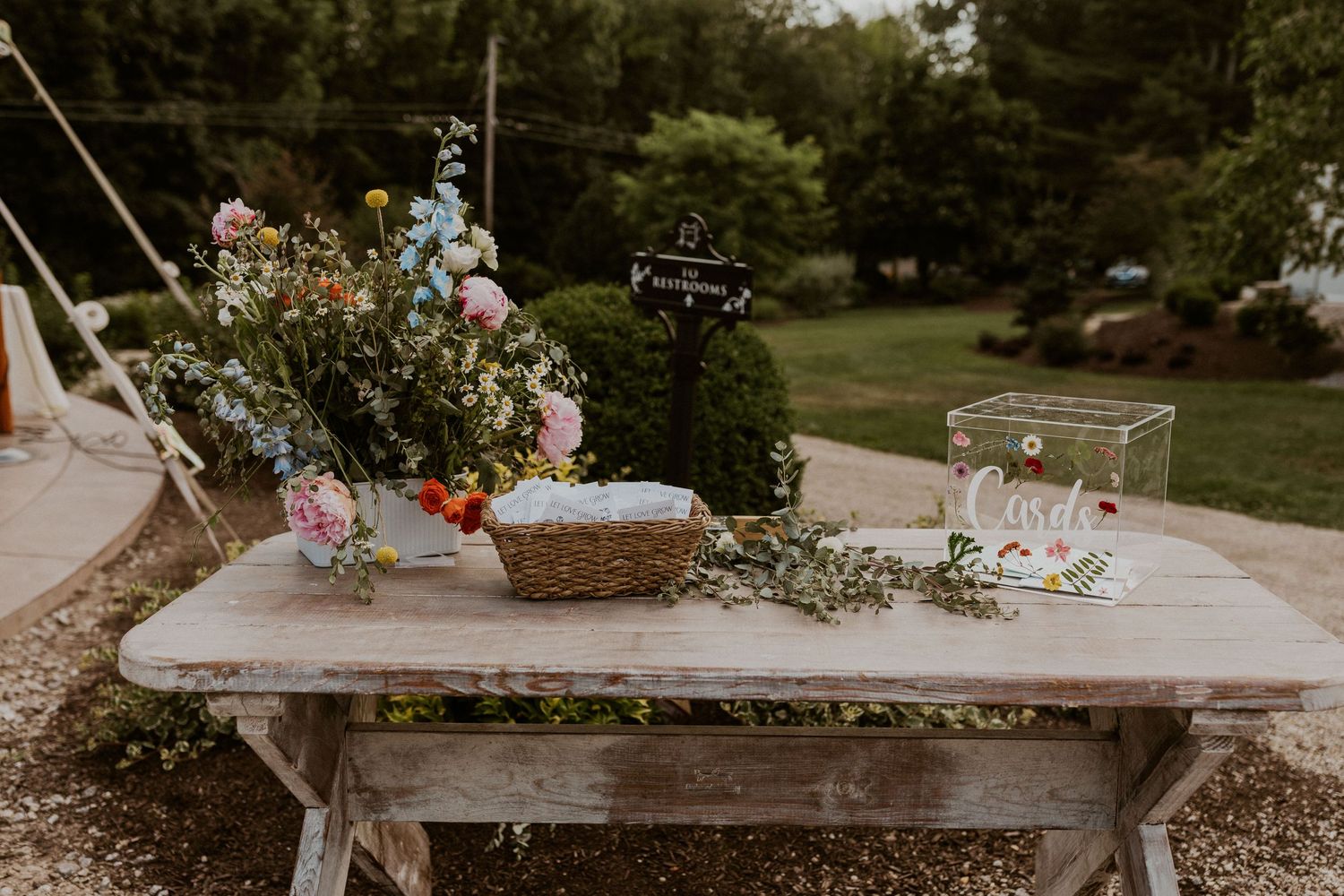 Rustic wedding decor display with vintage items and floral arrangements.