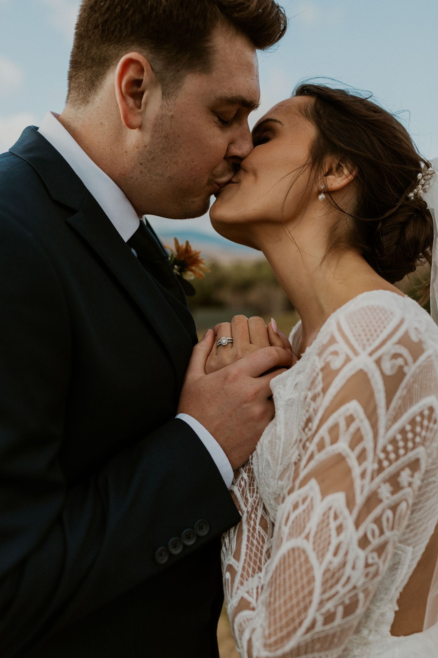 Bride and groom holding each other intimately during portraits at Owl's Nest Resort in Thornton, New Hampshire.