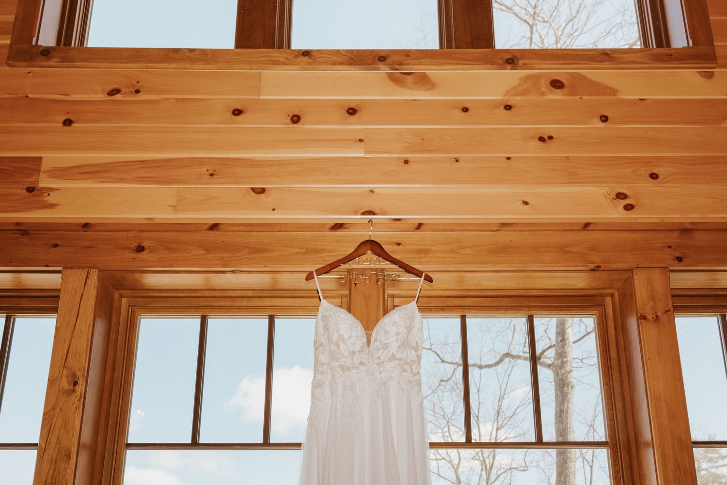 Wooden ceiling beams and windows create a warm, rustic architectural detail in a modern interior space.