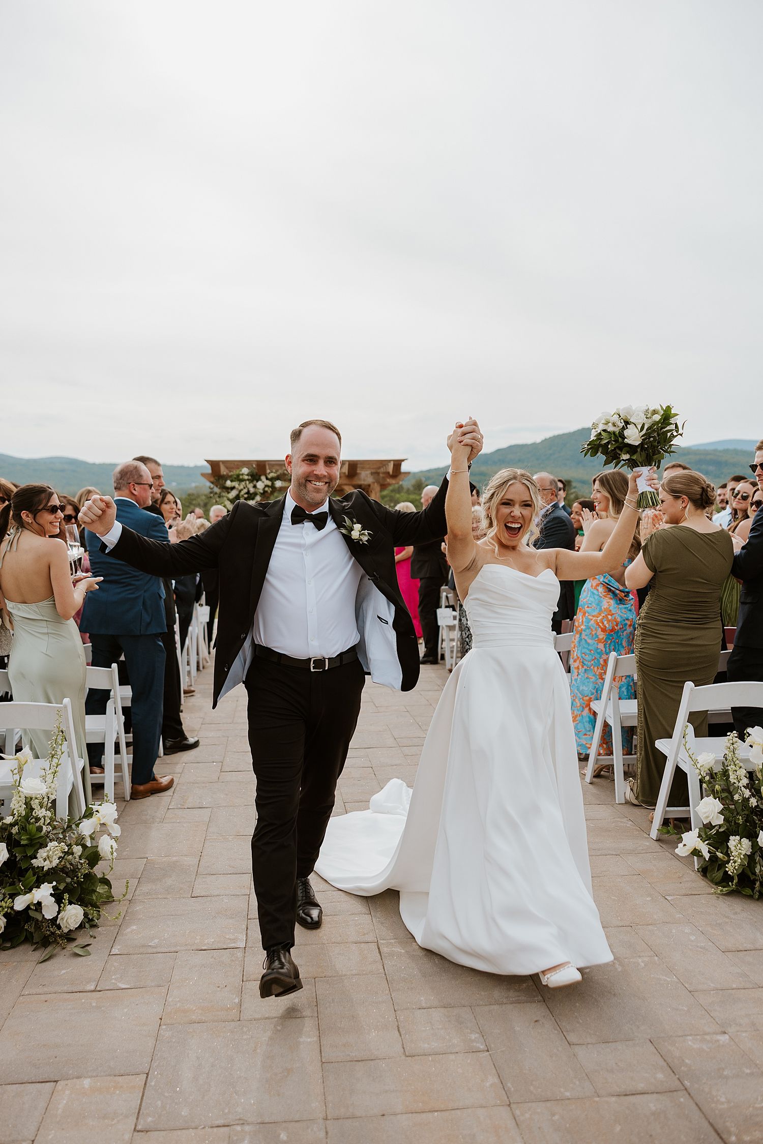 Bride and groom walking back down the aisle at their Owl's Nest Resort wedding in NH