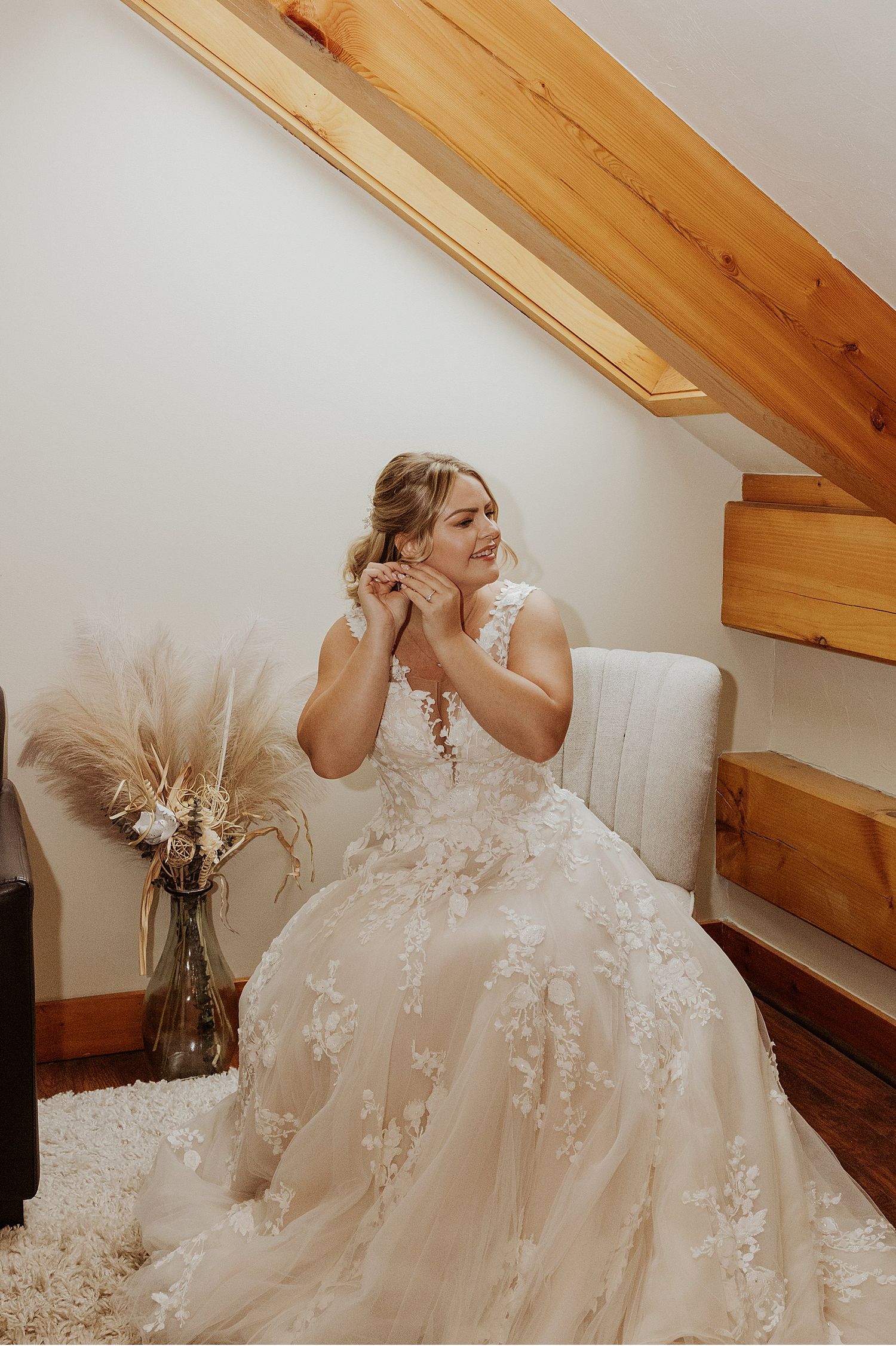Elegant lace wedding dress with delicate details photographed in natural window light.