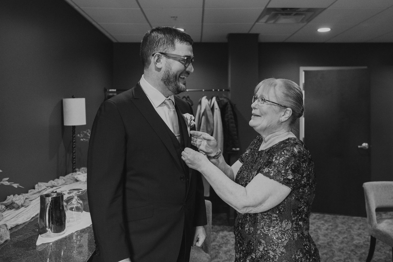 Couple dancing together in an indoor venue with warm lighting and elegant formal attire.
