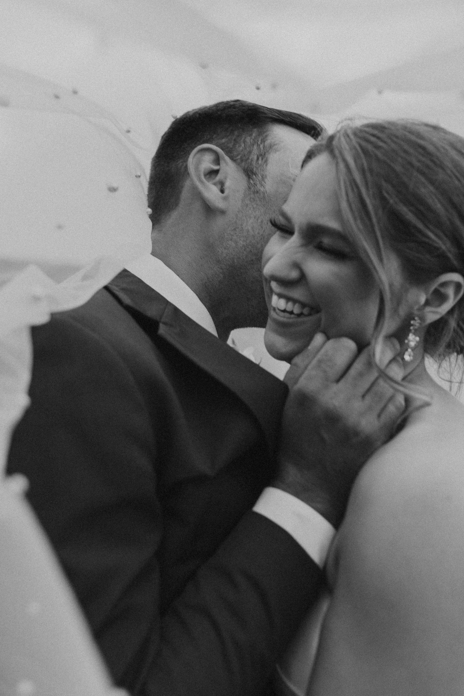 Wedding portrait of Kendra and Andrew under her veil at Owl's Nest Resort in Thornton New Hampshire.