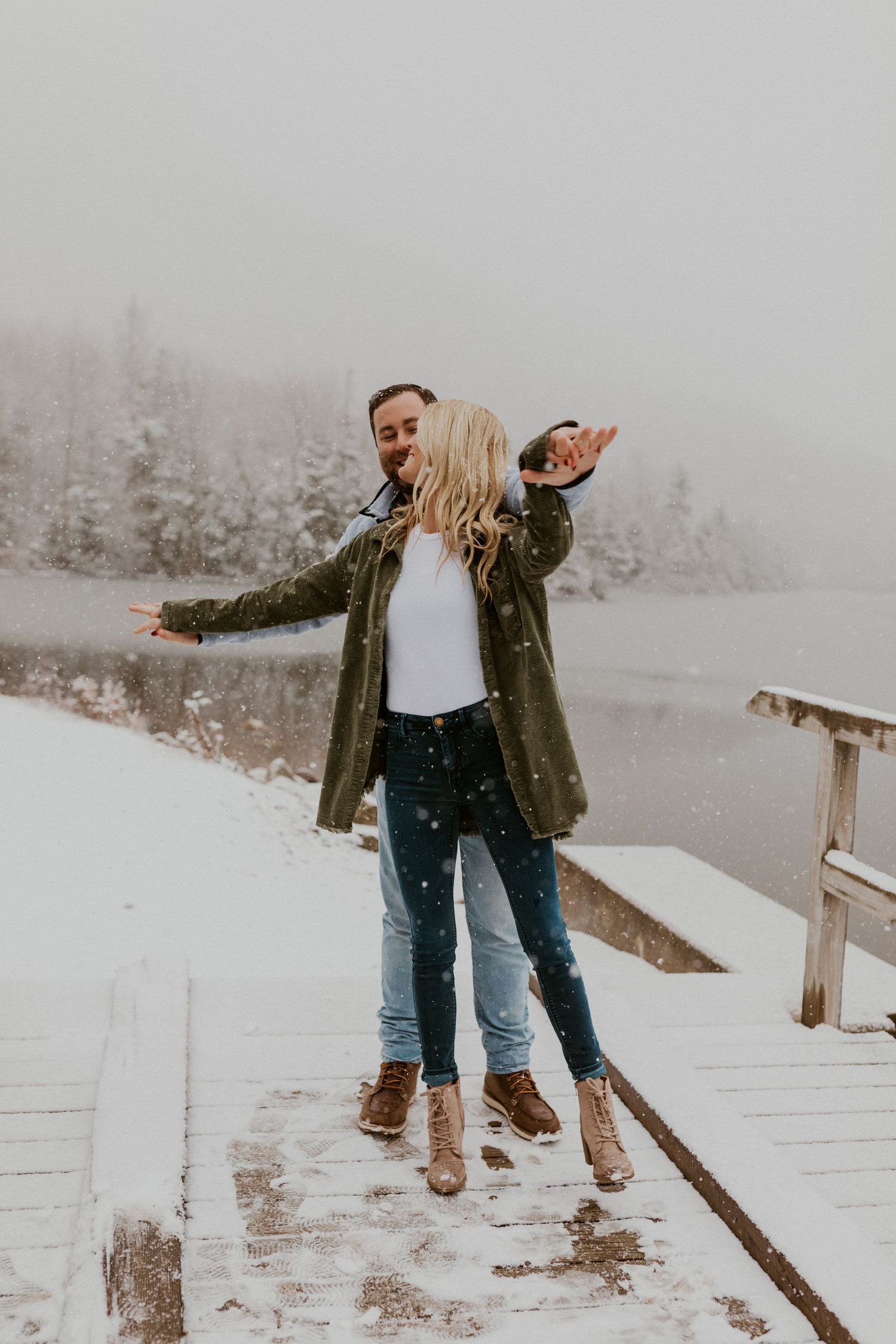 Newly engaged couple playfully posing for photos during their engagement session in Franconia New Hampshire.