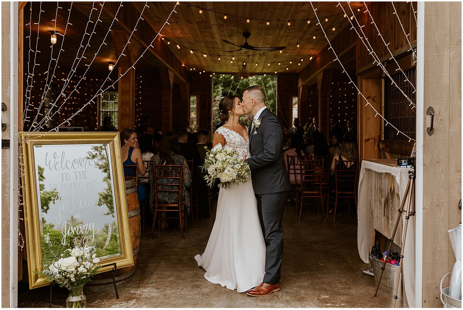 Rustic barn wedding venue decorated with string lights and elegant decor for evening celebration.