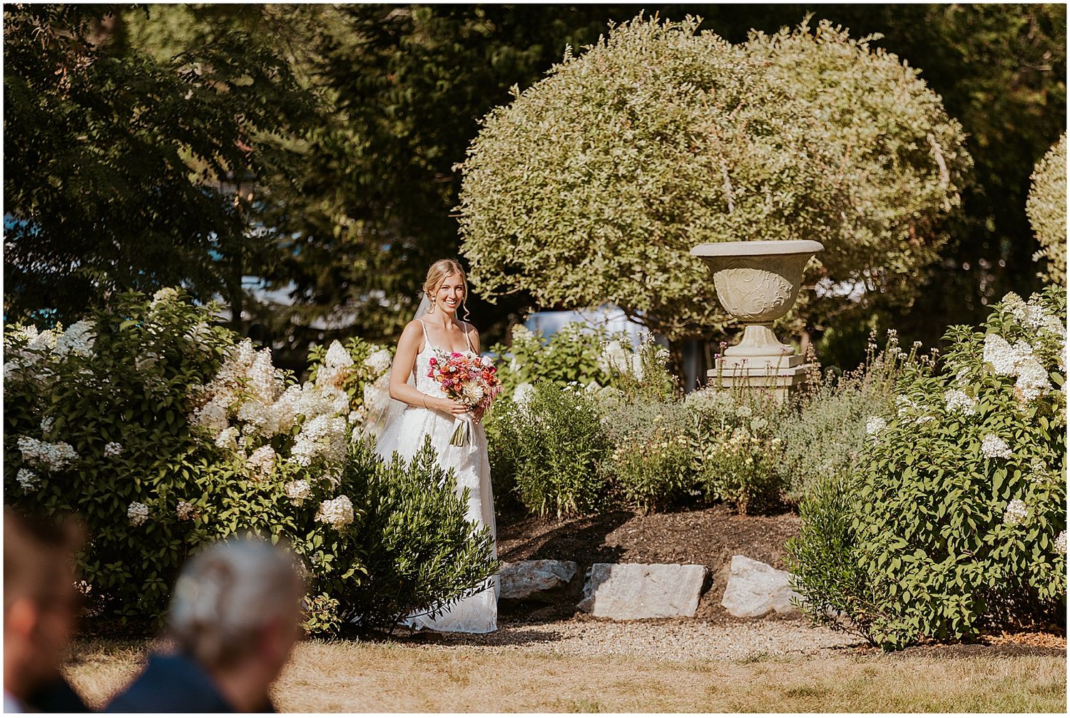 Outdoor garden wedding venue with blooming flowers and natural greenery.