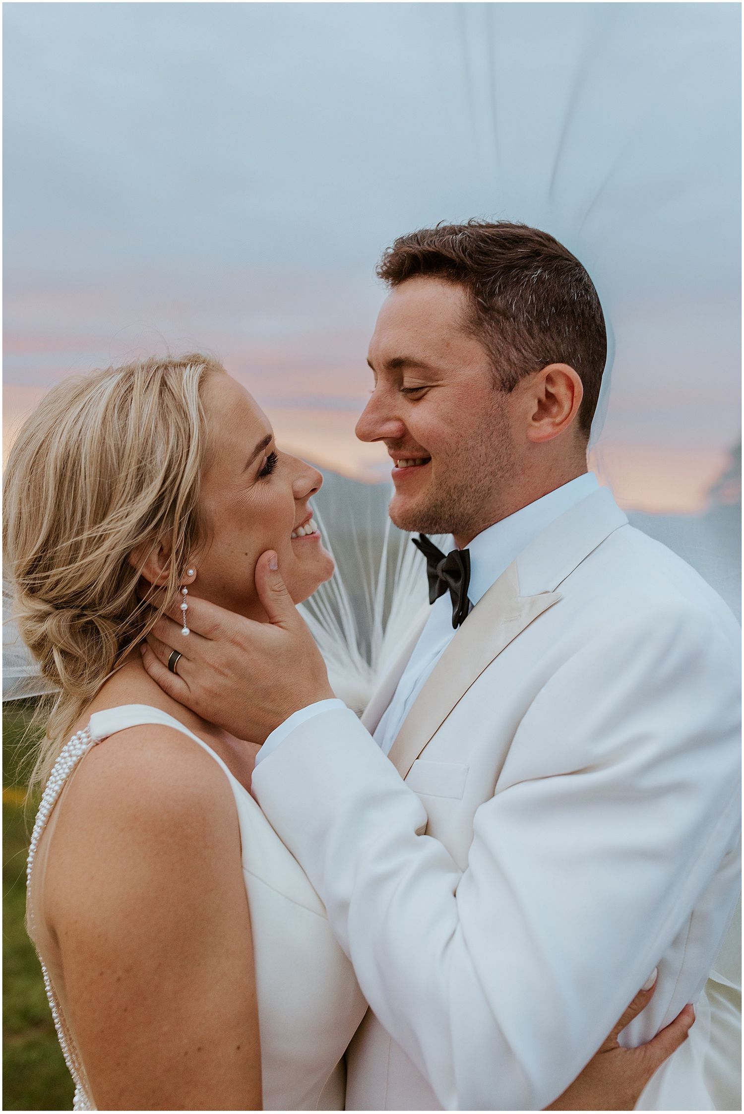 Bride and groom taking sunset photos at their NH mountain wedding