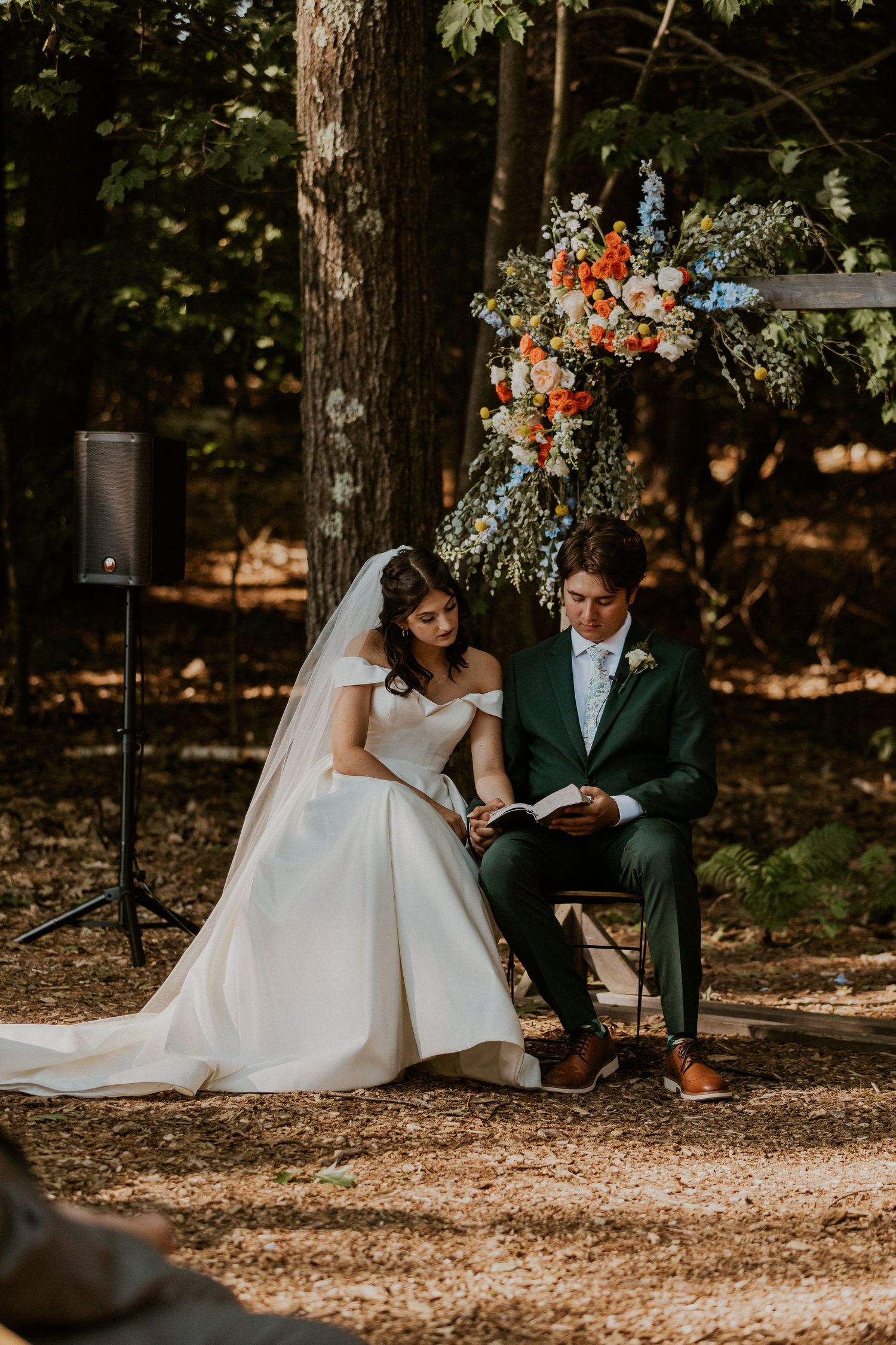 Couple sharing a quiet moment during their forest wedding ceremony.