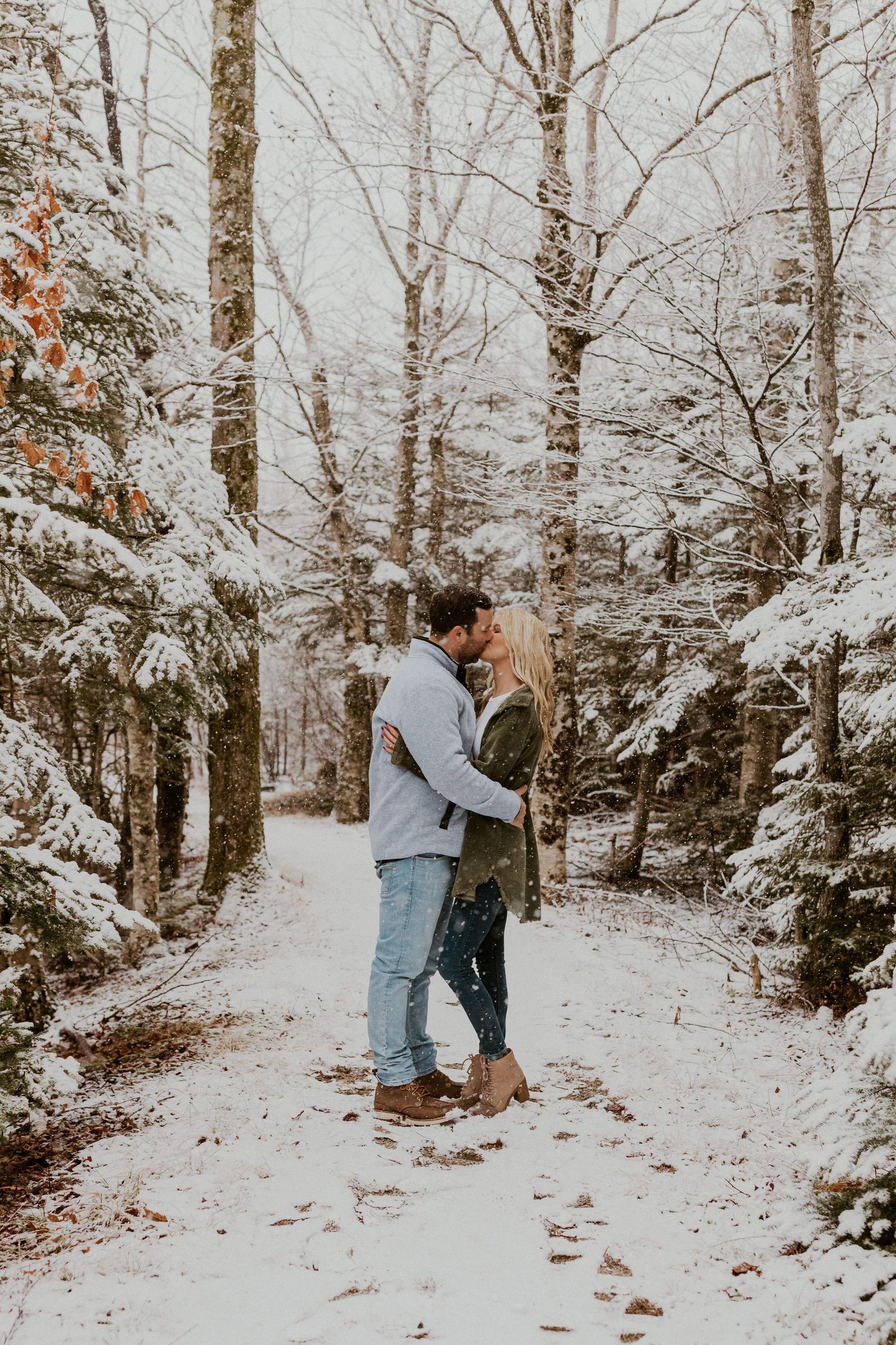 Newly engaged couple playfully posing for photos during their engagement session in Franconia New Hampshire.