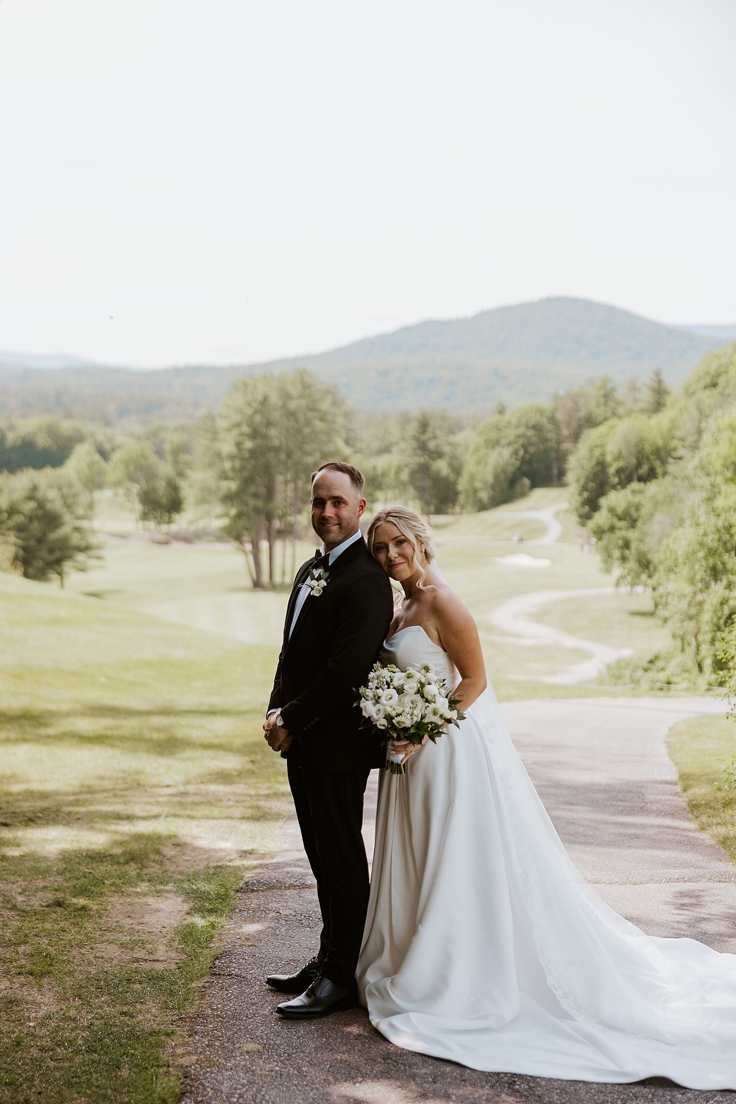 Bride and groom taking portraits at their Owl's Nest wedding in NH