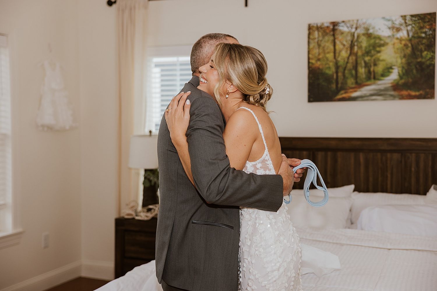 Bride hugging her dad while getting ready for her New Hampshire wedding