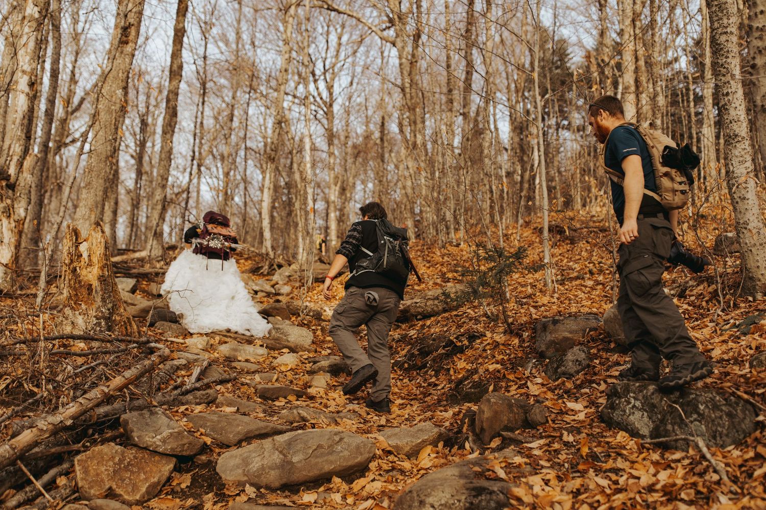 Jackie and Andy Brosonski hike the West Ridge Trail on Mount Cardigan in their wedding attire.