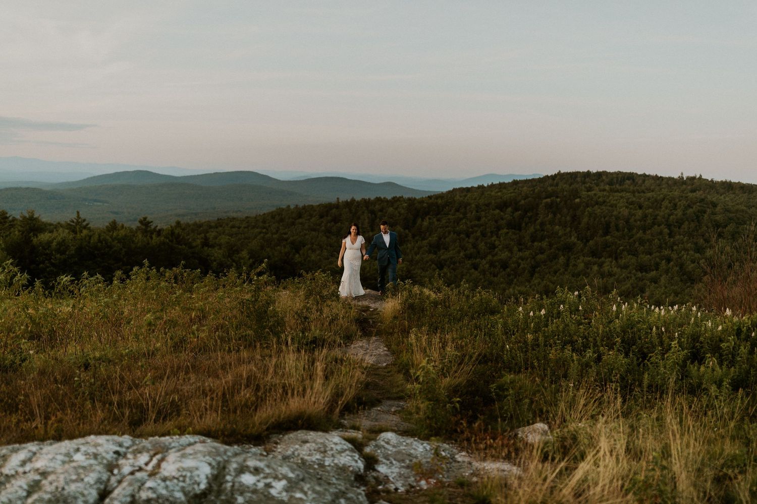Danielle and Colin dressed in their wedding attire for their one year anniversary photoshoot on Foss Mountain in NH.