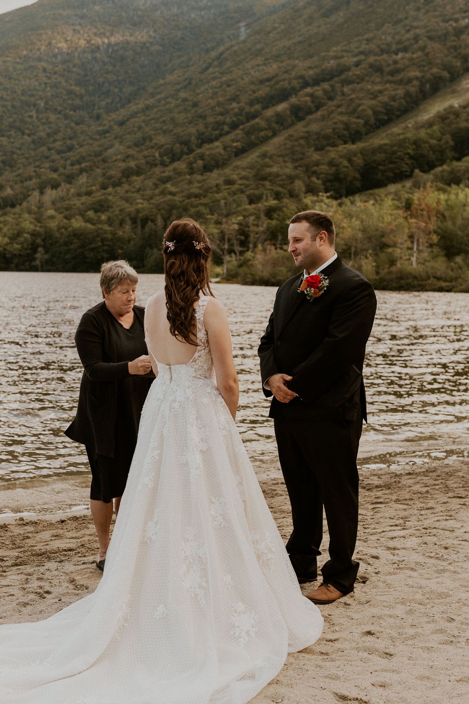 Bride and groom hold hands in front of the justice of the peace while declaring their love to each other.