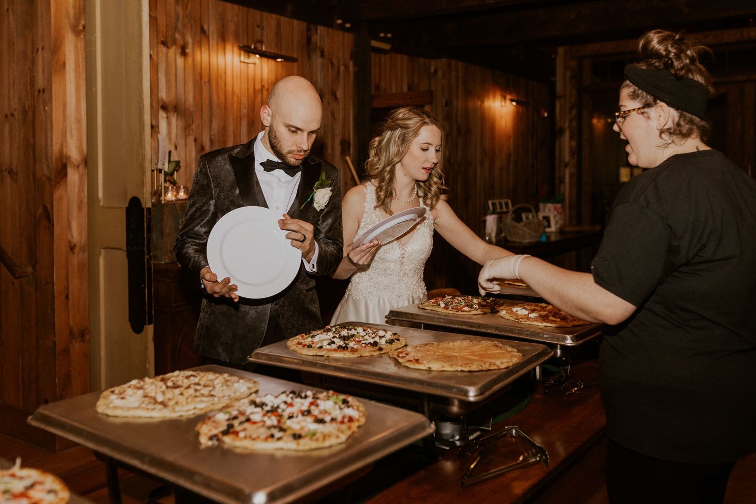 Deirdre and Brodie getting some pizza for dinner at their wedding reception in Tamworth New Hampshire.