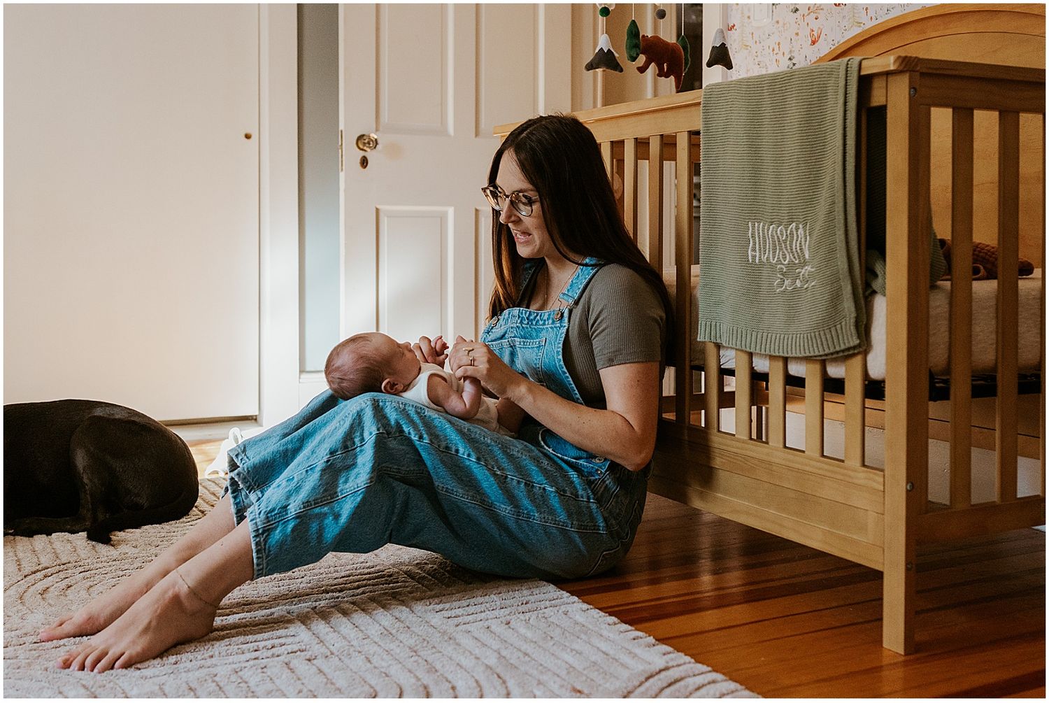 NH mom taking newborn family photos at home with her baby and dog