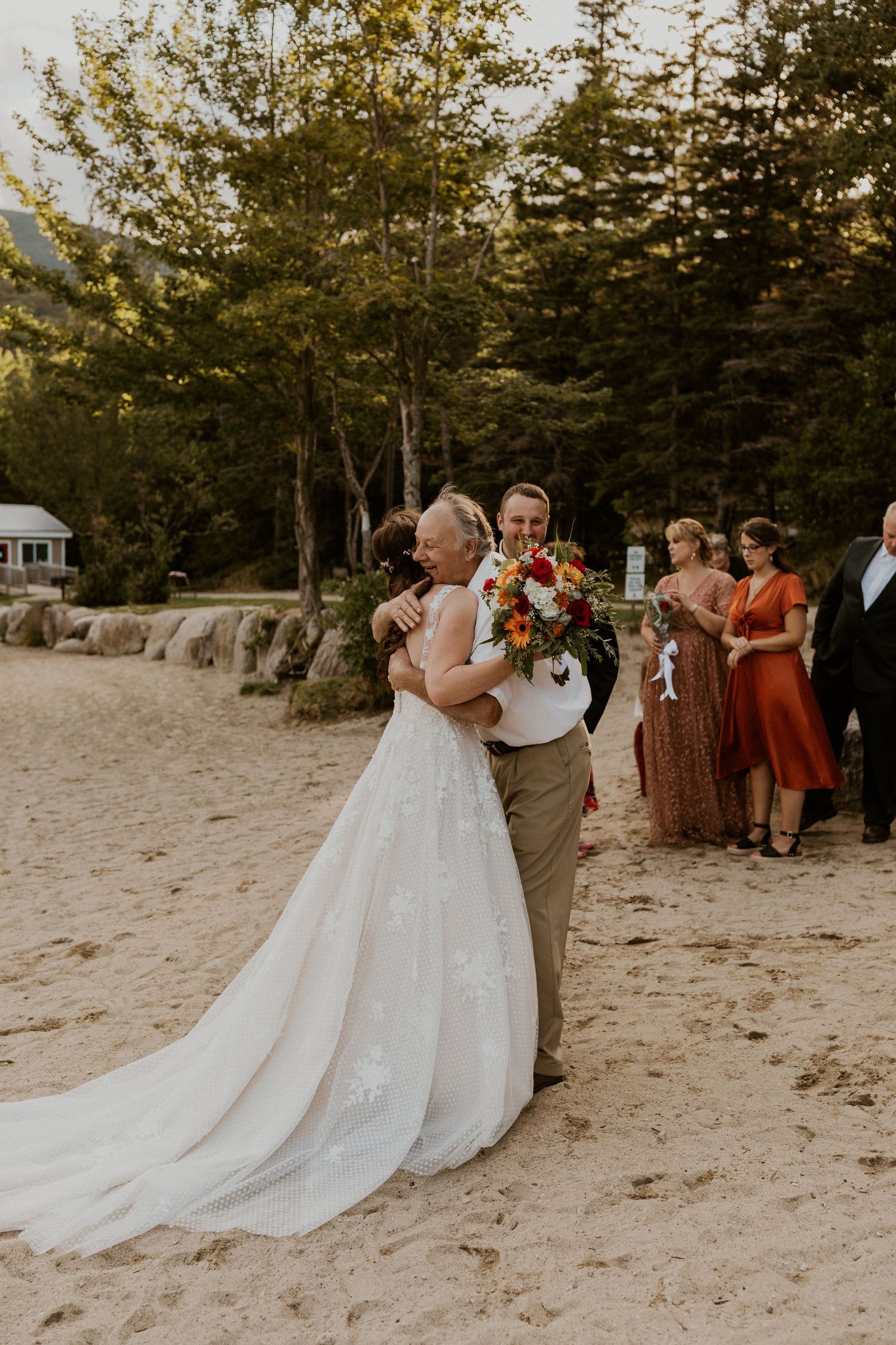 Family congratulating the couple after their intimate elopement ceremony in the white mountains.