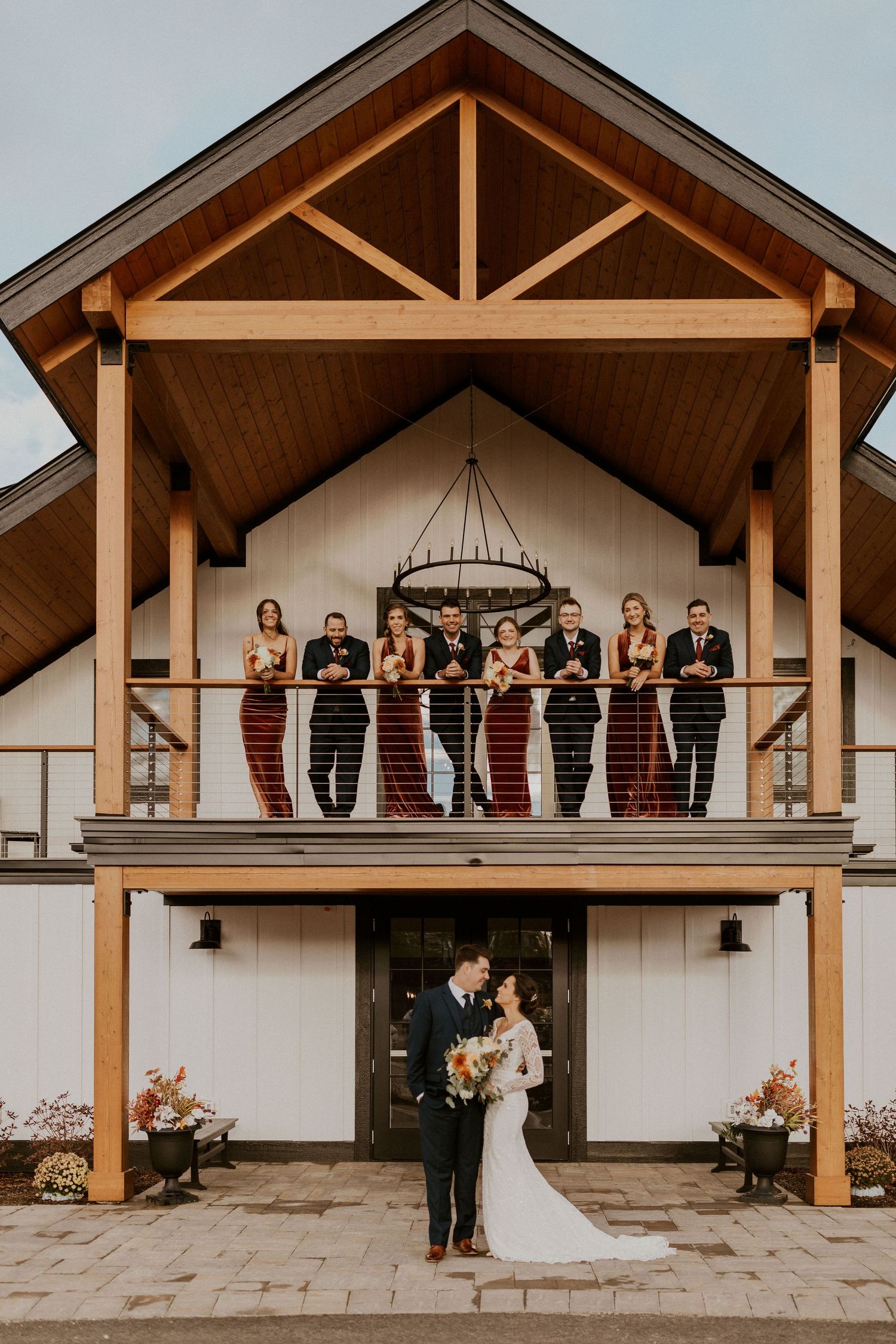 The whole wedding party posed on the new Lake House at the Owl's Nest Resort in Thornton NH.