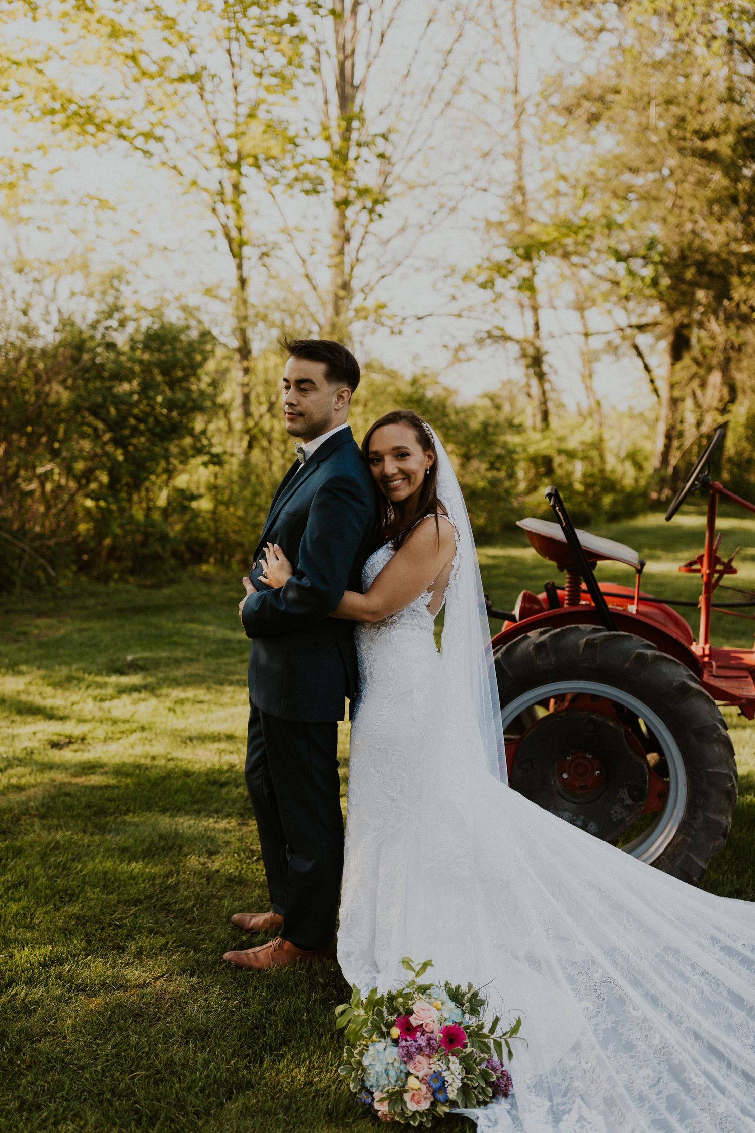 Chrissy embracing Mike for a portrait. The tractor is in the background.