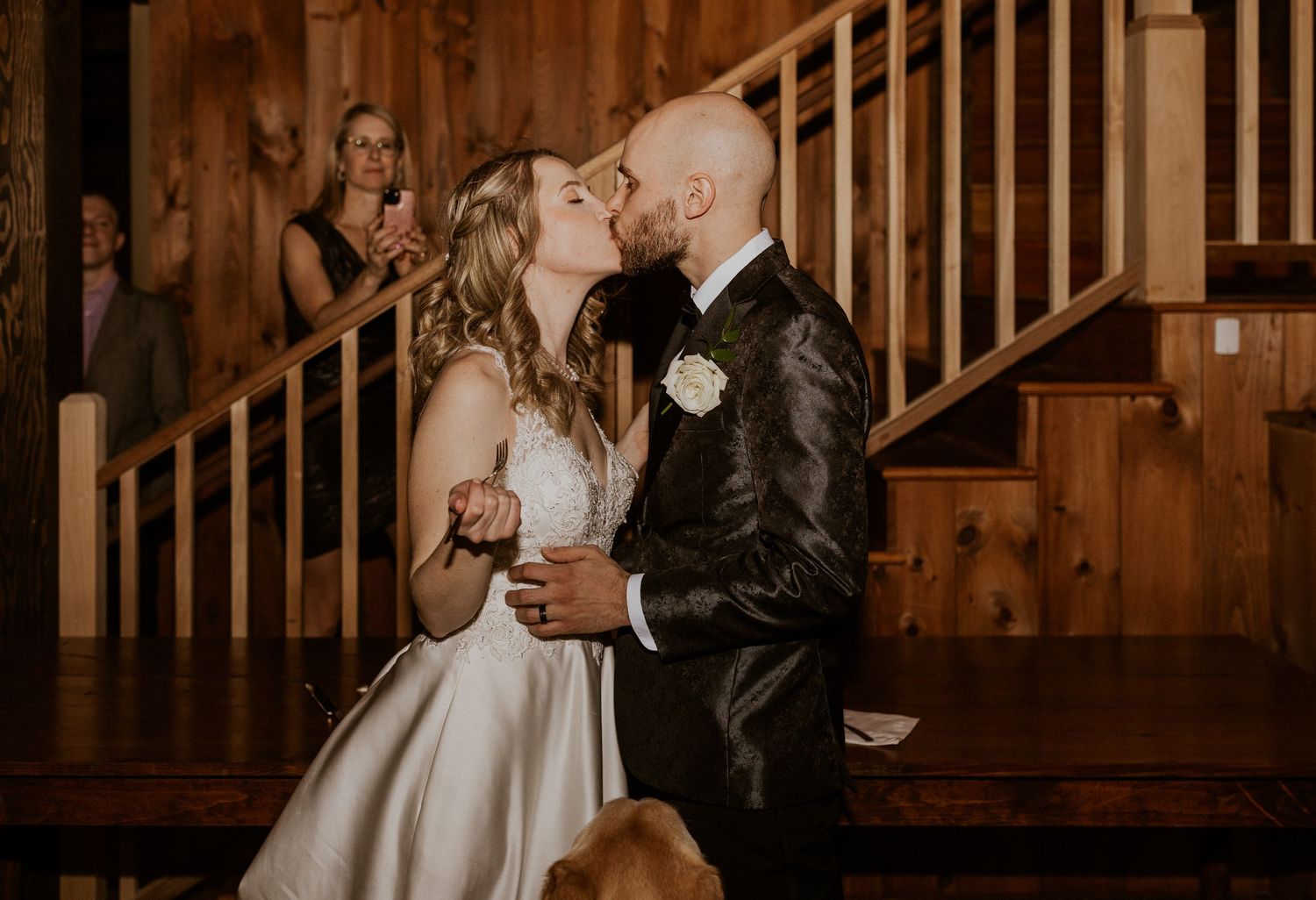 Deirdre and Brodie sharing a kiss after cutting their wedding cake together.