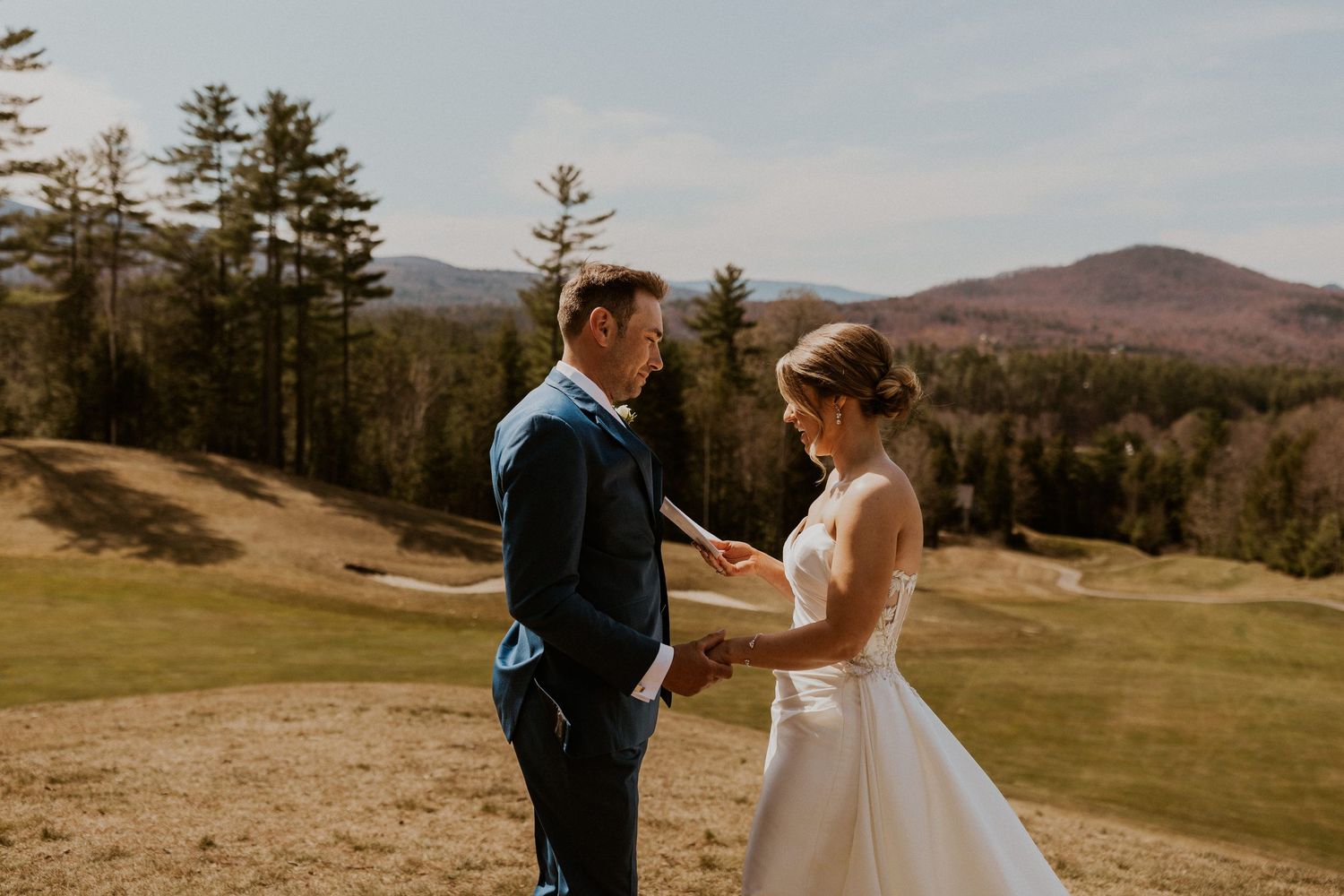 Kendra reading her private vows to Andrew on the sunny golf course at Owl's Nest Resort.