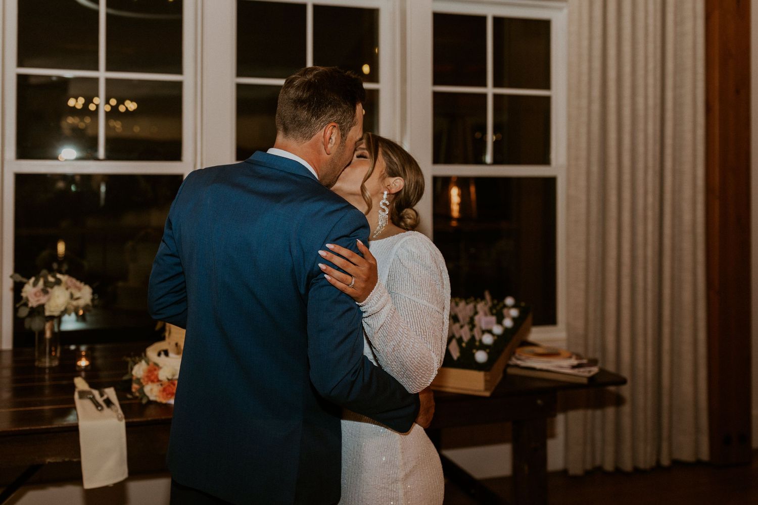 Kendra and Andrew kissing after sharing cake together at their Owl's Nest Resort Wedding