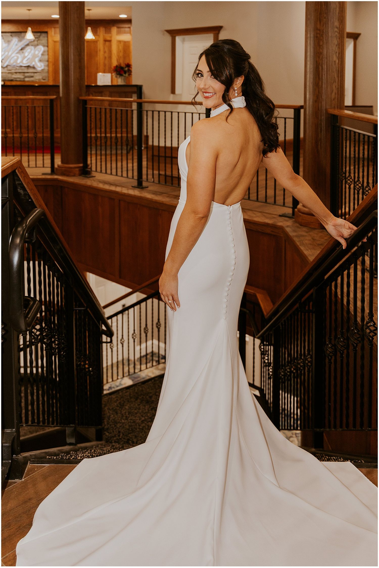 Bride in a backless bridal gown at River Walk Resort NH