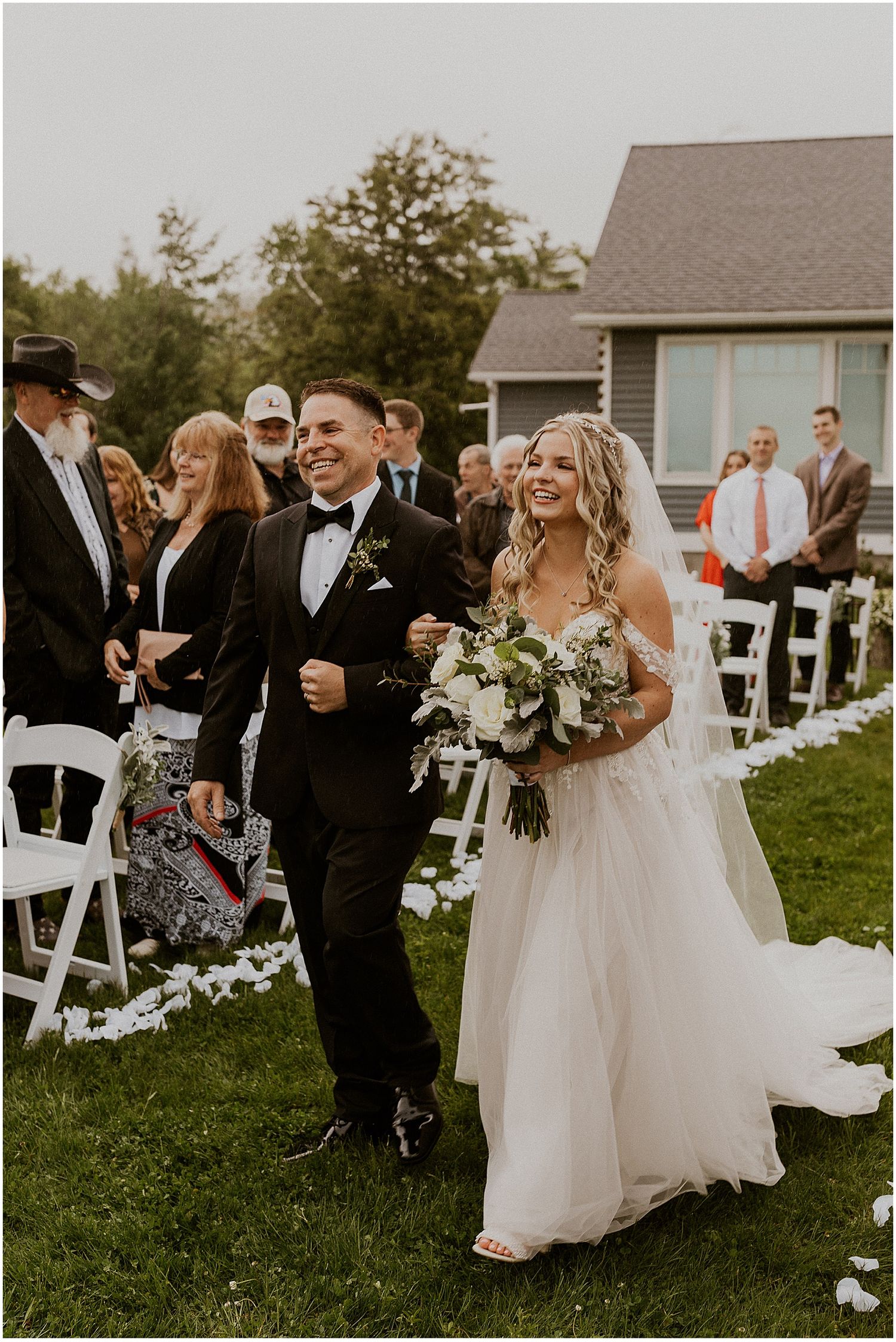 Bride walking down the aisle at her NH rainy wedding ceremony