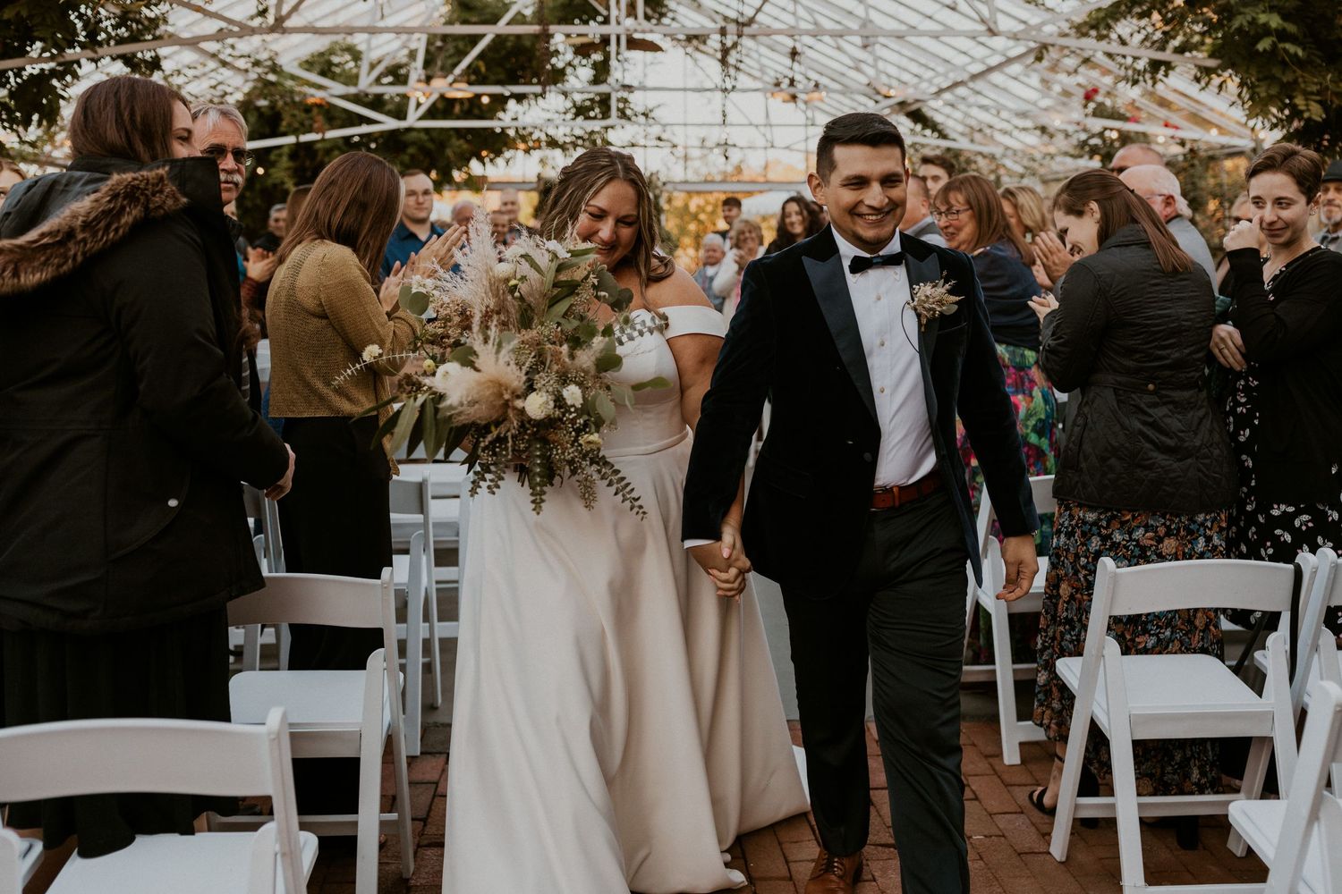 Terise and Jose walking up the aisle after their wedding ceremony at the Barn on the Pemi in Plymouth NH.