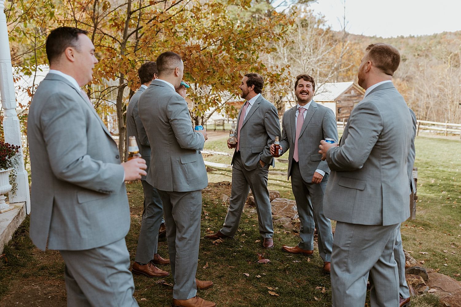 Groom and groomsmen having a beer before a New Hampshire wedding in the mountains