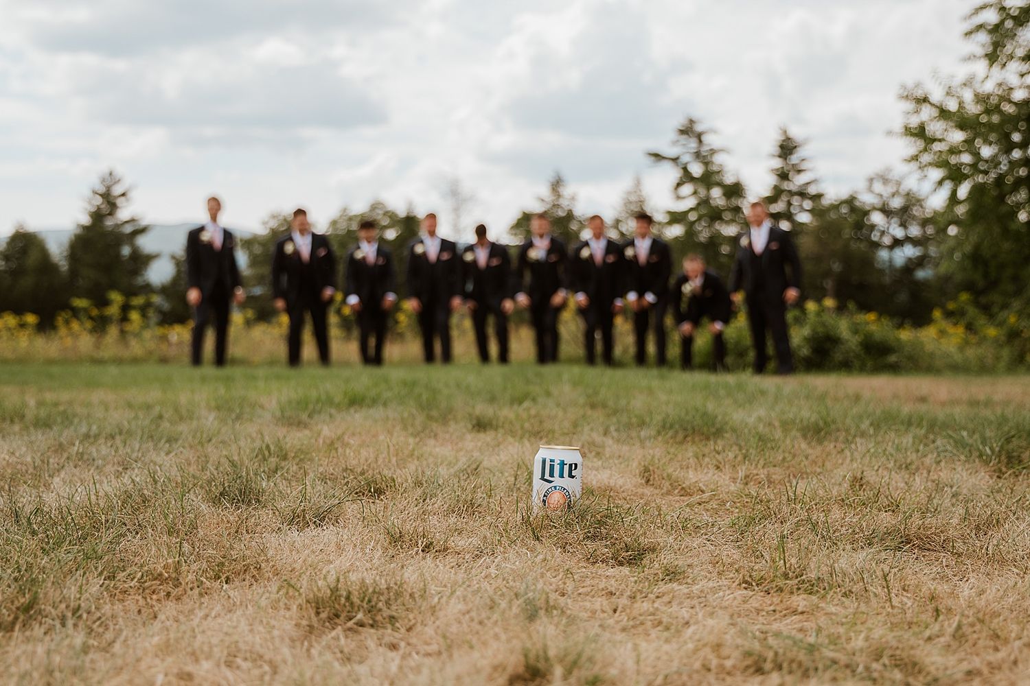 Groom and groomsmen taking portrait photos at a New hampshire wedding at Owl's Nest