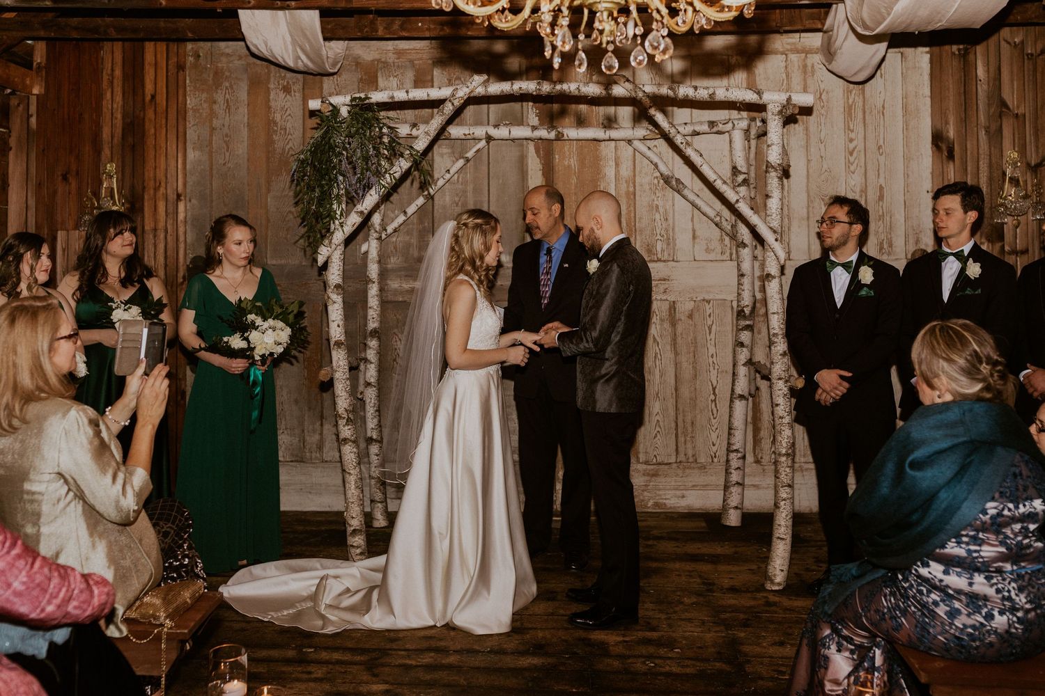 Deirdre and Brodie hand in hand during their wedding ceremony in Tamworth New Hampshire.