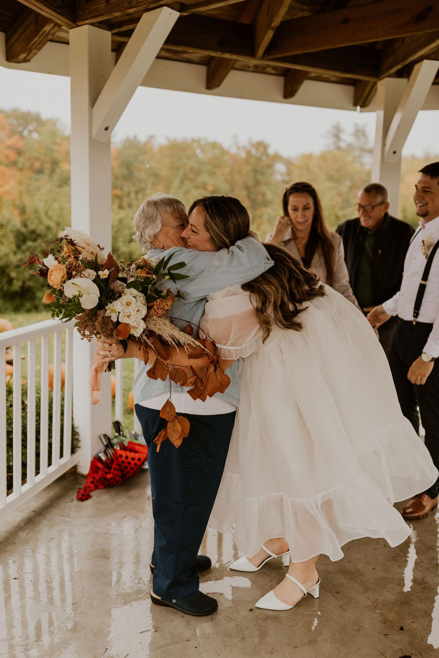 Terise hugging her grandmother after the elopement ceremony at Carter Hill Orchard in Concord New Hampshire.