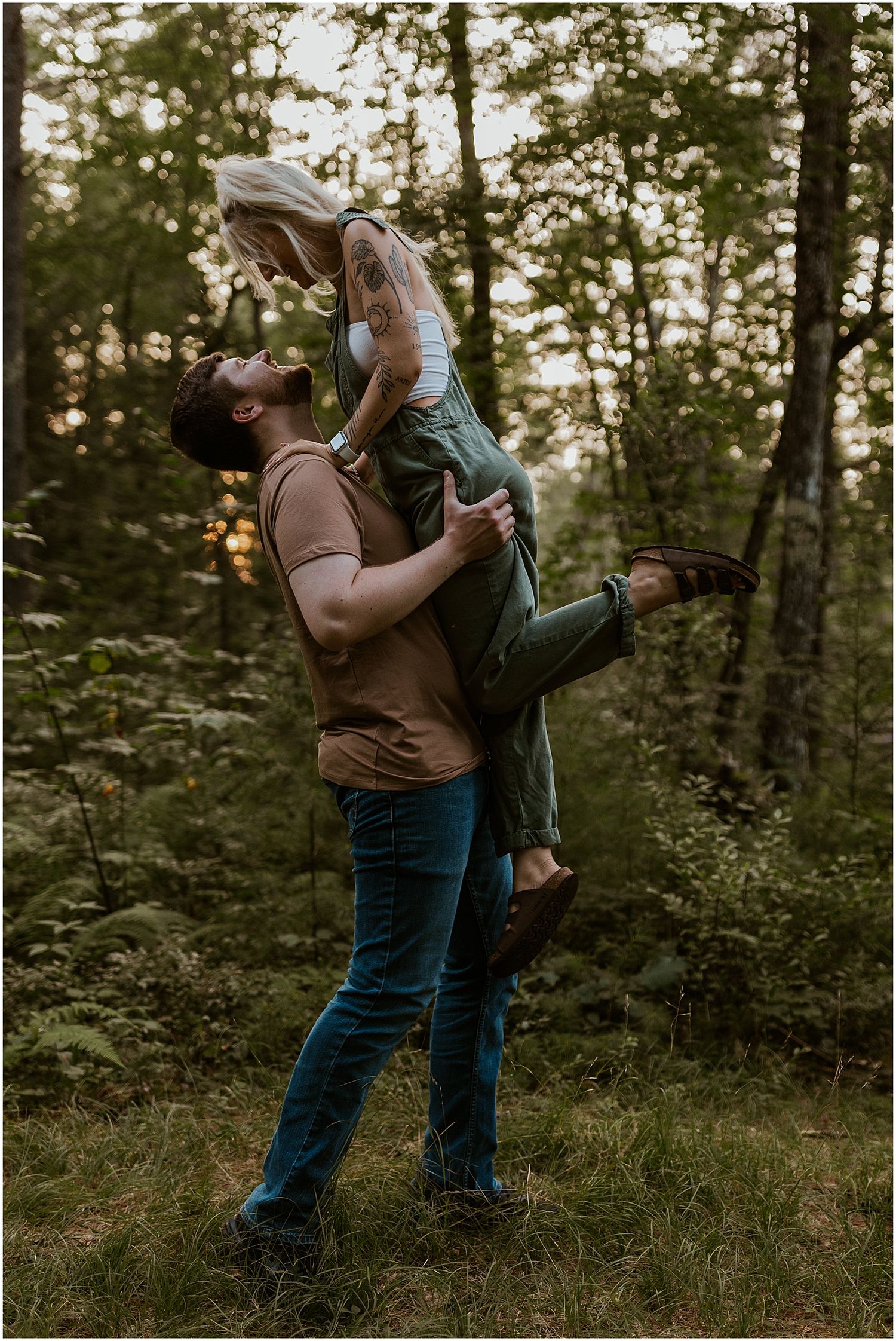 A romantic sunset engagement session in a wooded forest setting.