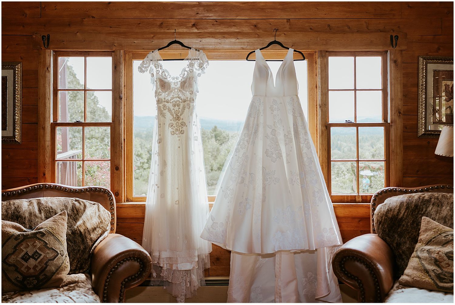 Bridal gowns hanging in a window for a Longlook Farm wedding in NH
