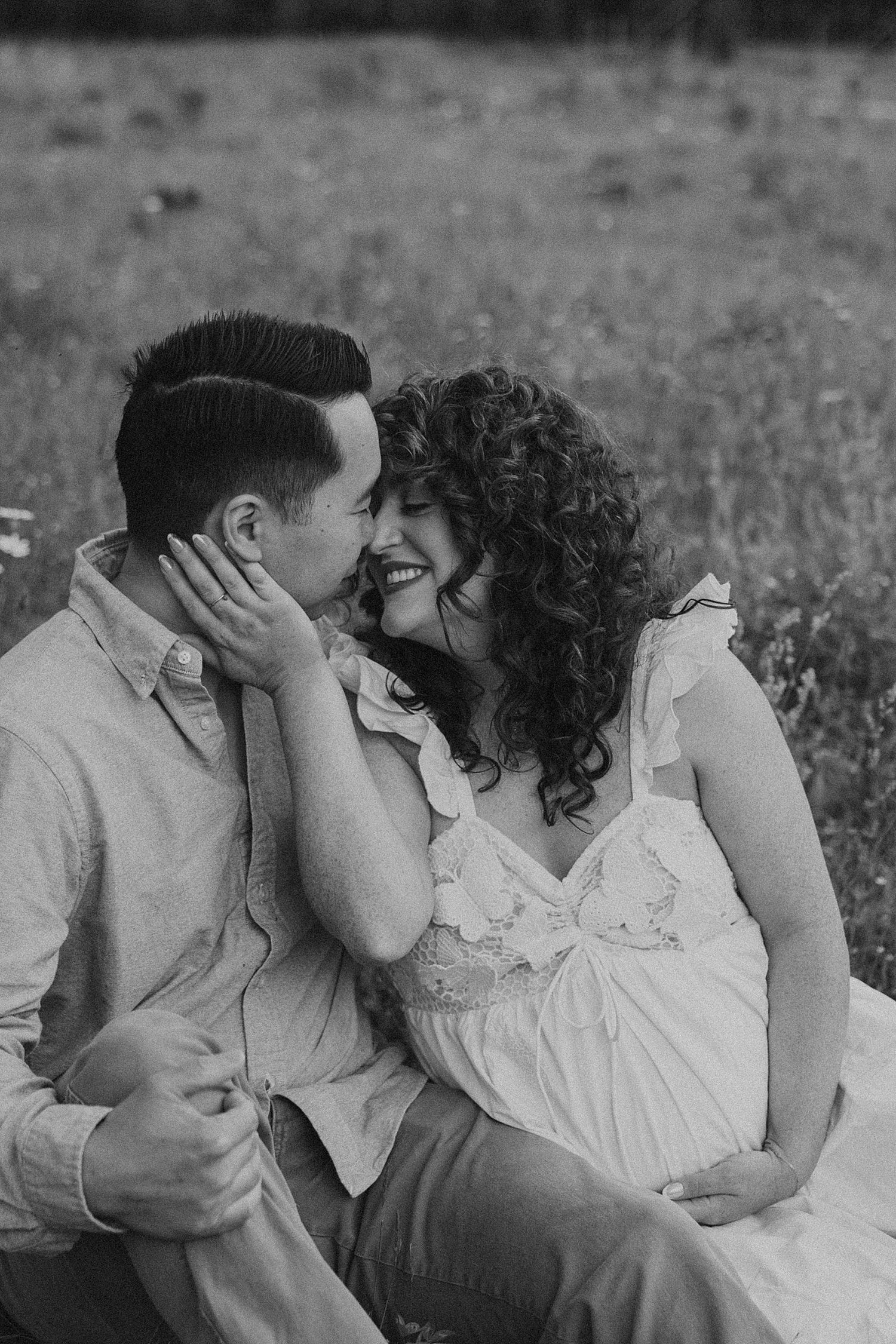 New Hampshire couple taking maternity photos in a field in the White Mountains