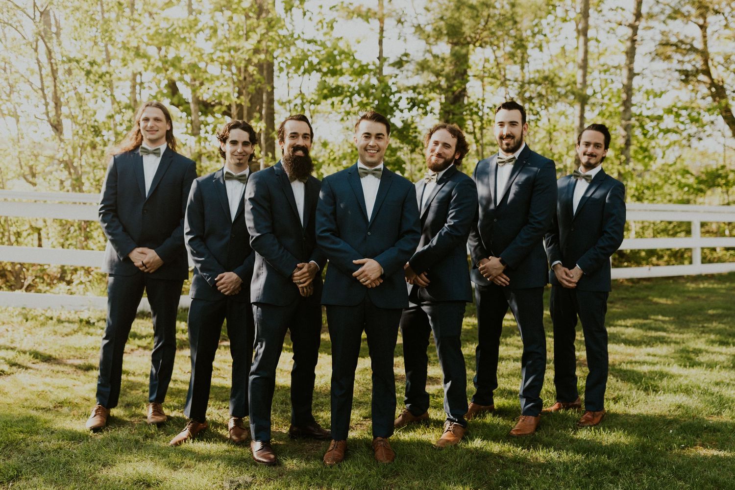 Groomsmen group photo where everyone is standing together and smiling.