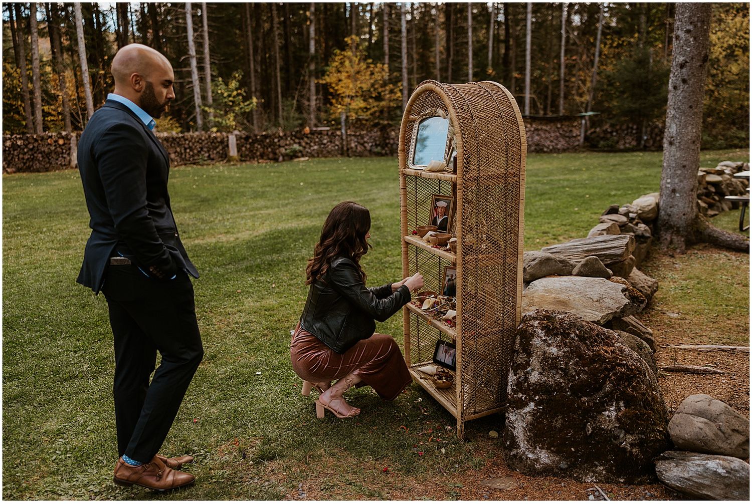 Outdoor wedding ceremony setup with wooden arch and natural fall decorations.