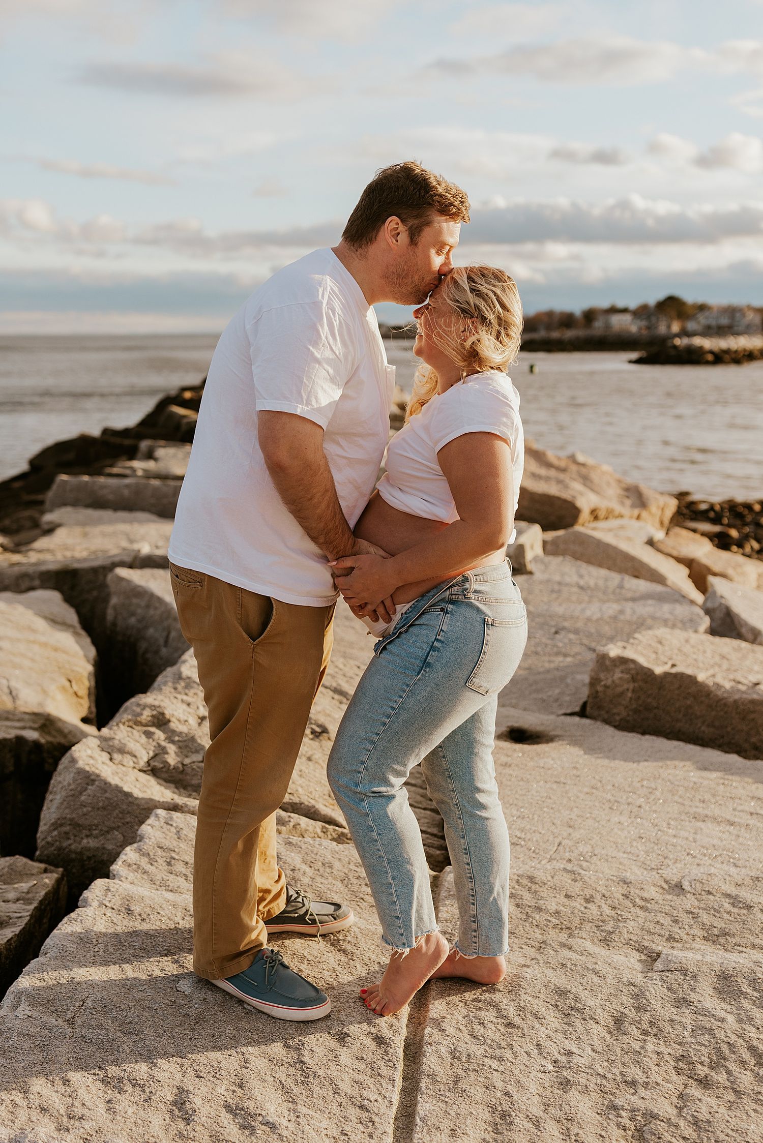 Couple doing a New Hampshire photoshoot for maternity photos at the beach