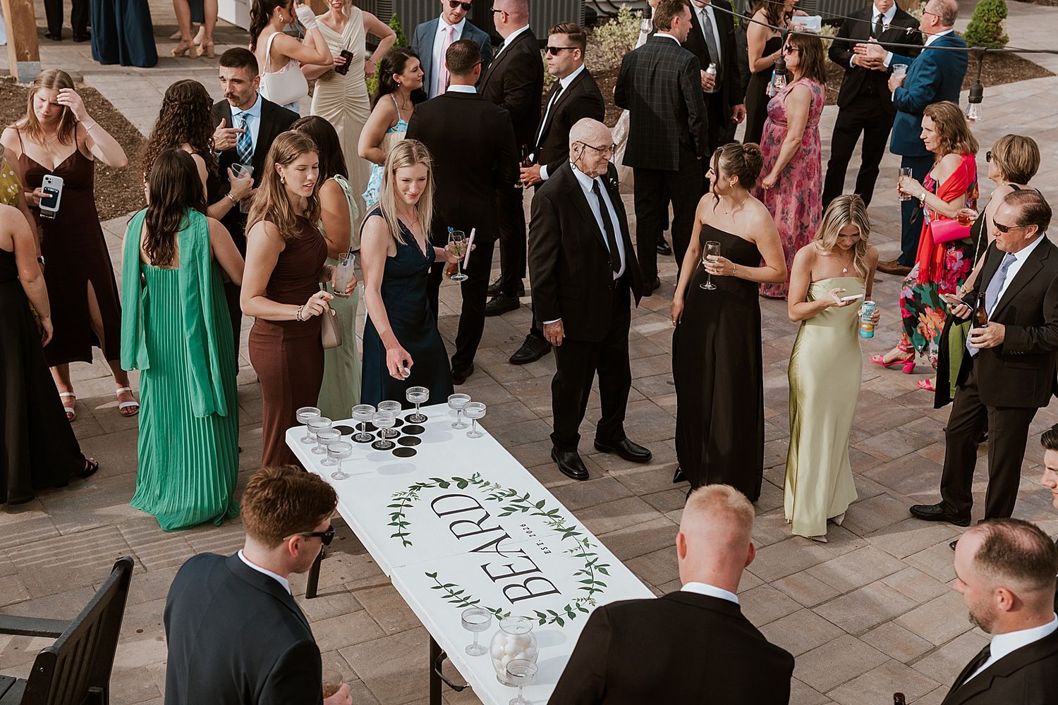 Guests playing beer pong with champagne at a wedding cocktail hour at the Owls Nest Resort in NH