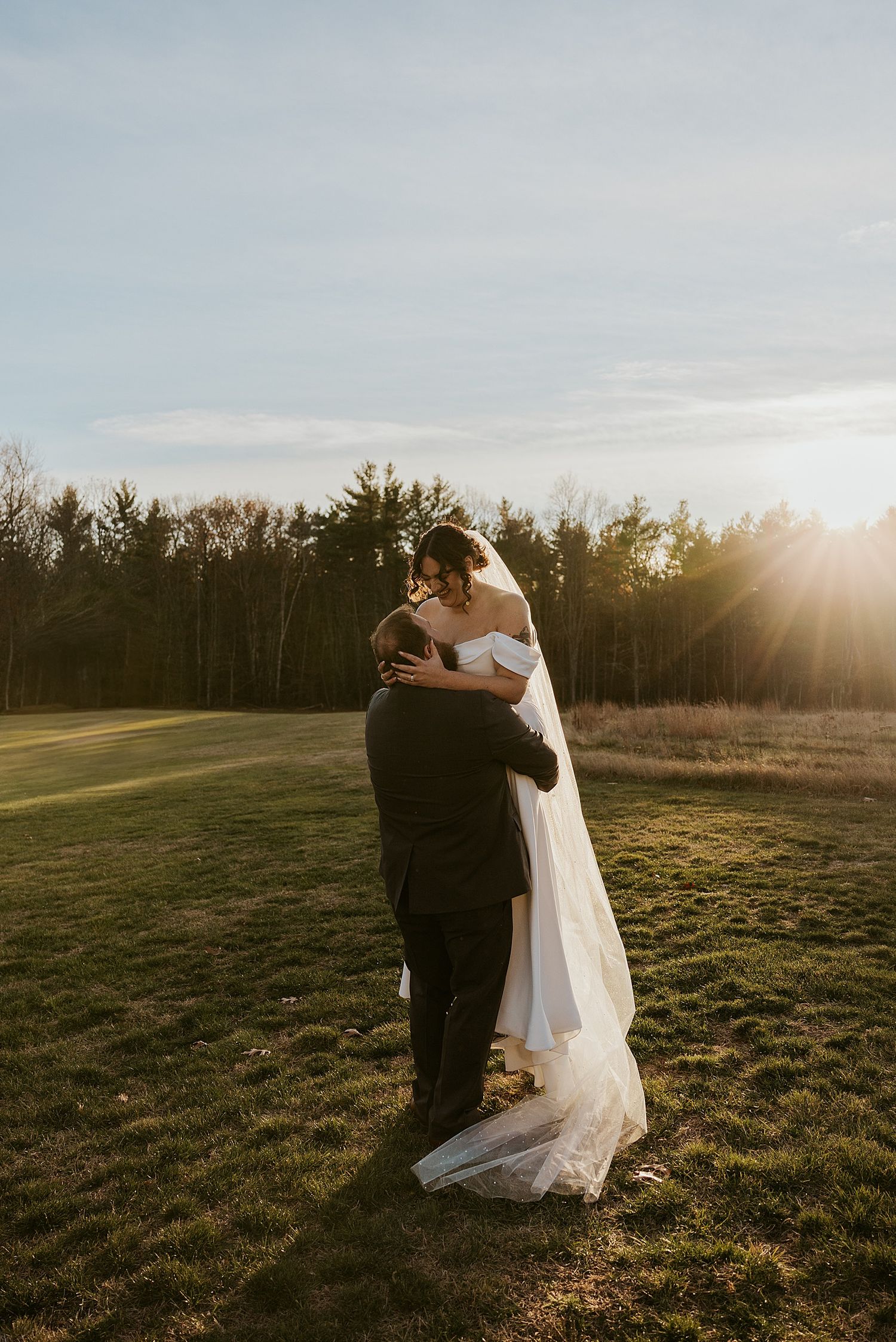 Bride and groom taking sunset portraits on their wedding day at The Barn At Powder Major's Farm in New Hampshire