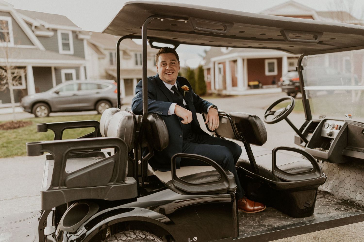 Keegan driving away in a golf cart to get ready for the first look with Abbie.