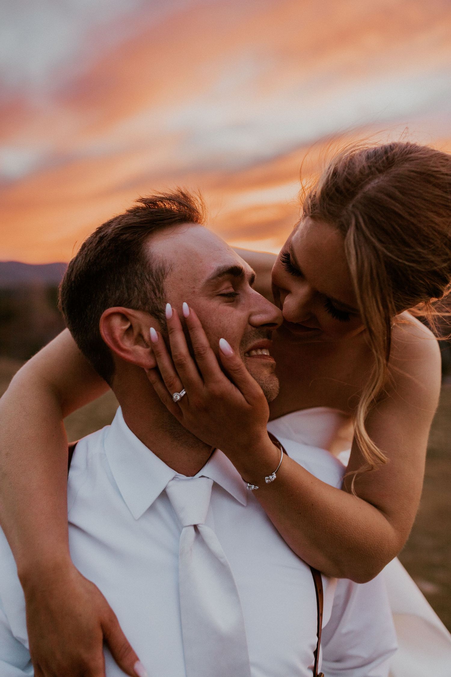 Kendra embracing Andrew during sunset wedding portraits at Owl's Nest Resort.