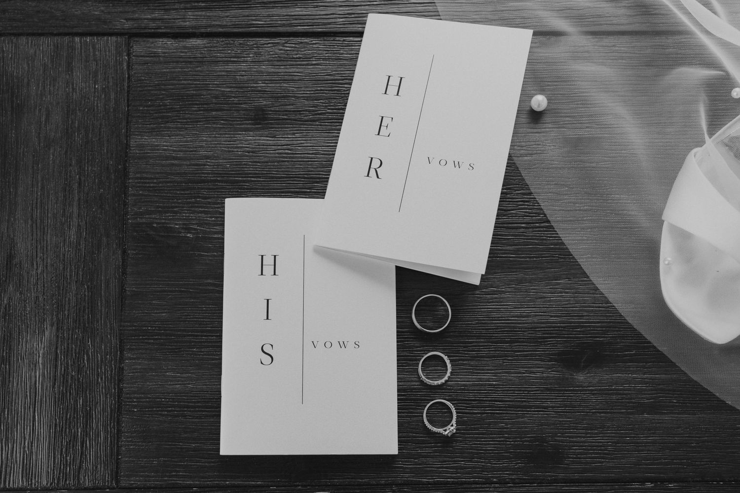 A black and white flat lay photograph of Kendra and Andrew's wedding vows.