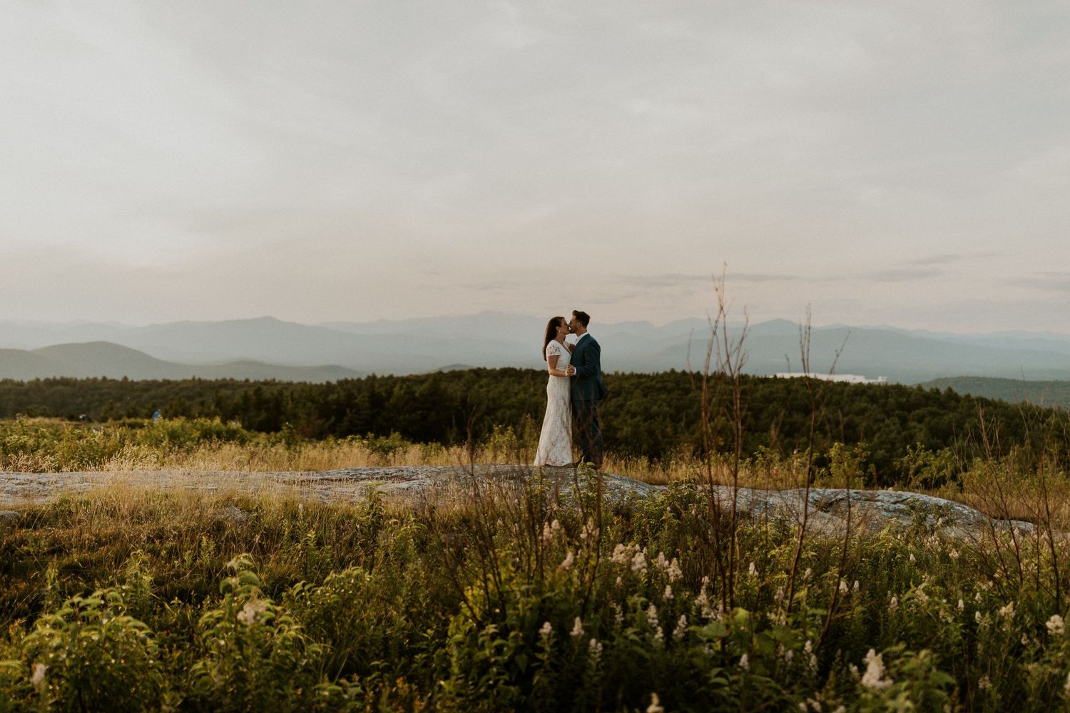 Danielle and Colin dressed in their wedding attire for their one year anniversary photoshoot on Foss Mountain in NH.