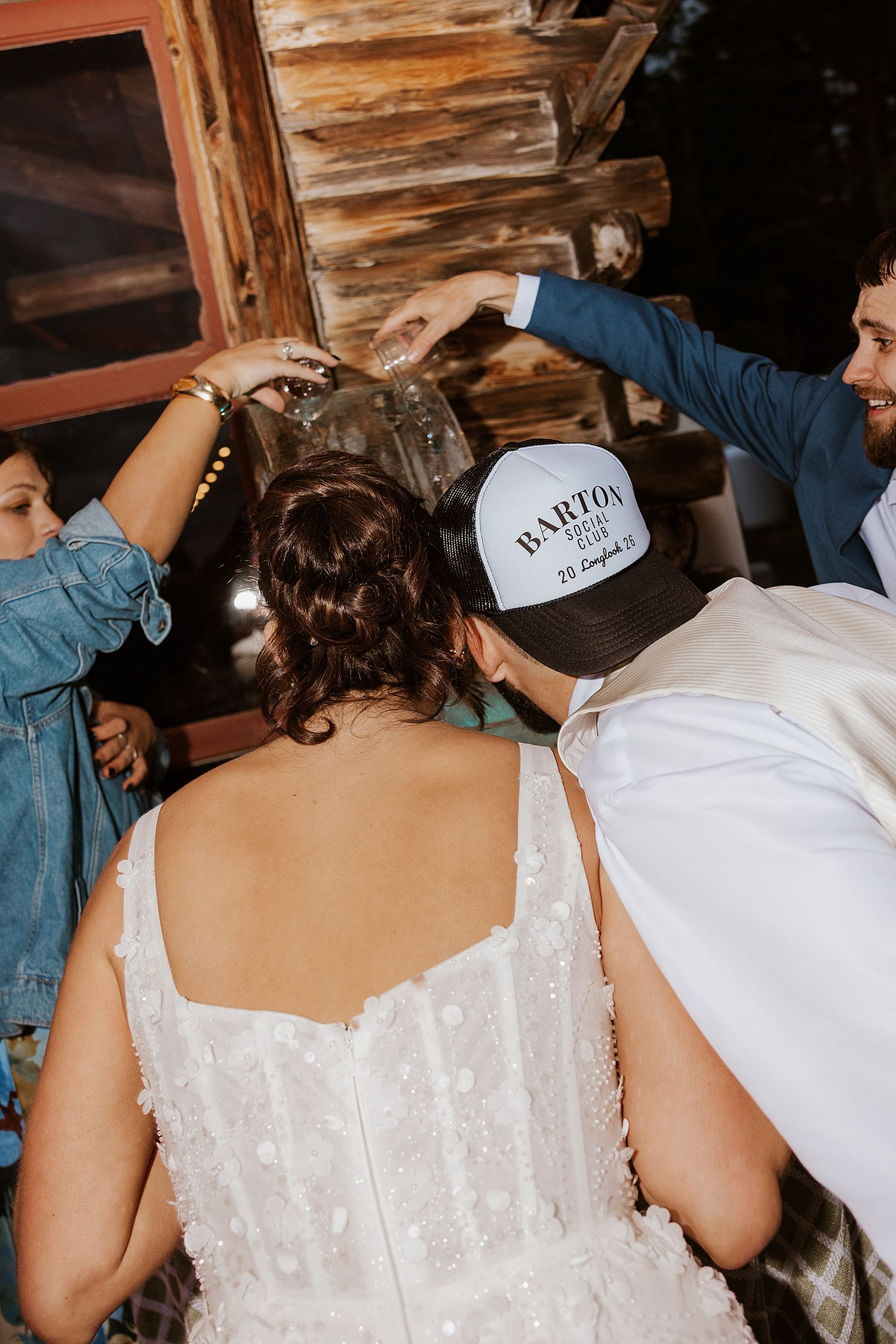 Bride and groom doing a shot luge at their NH wedding