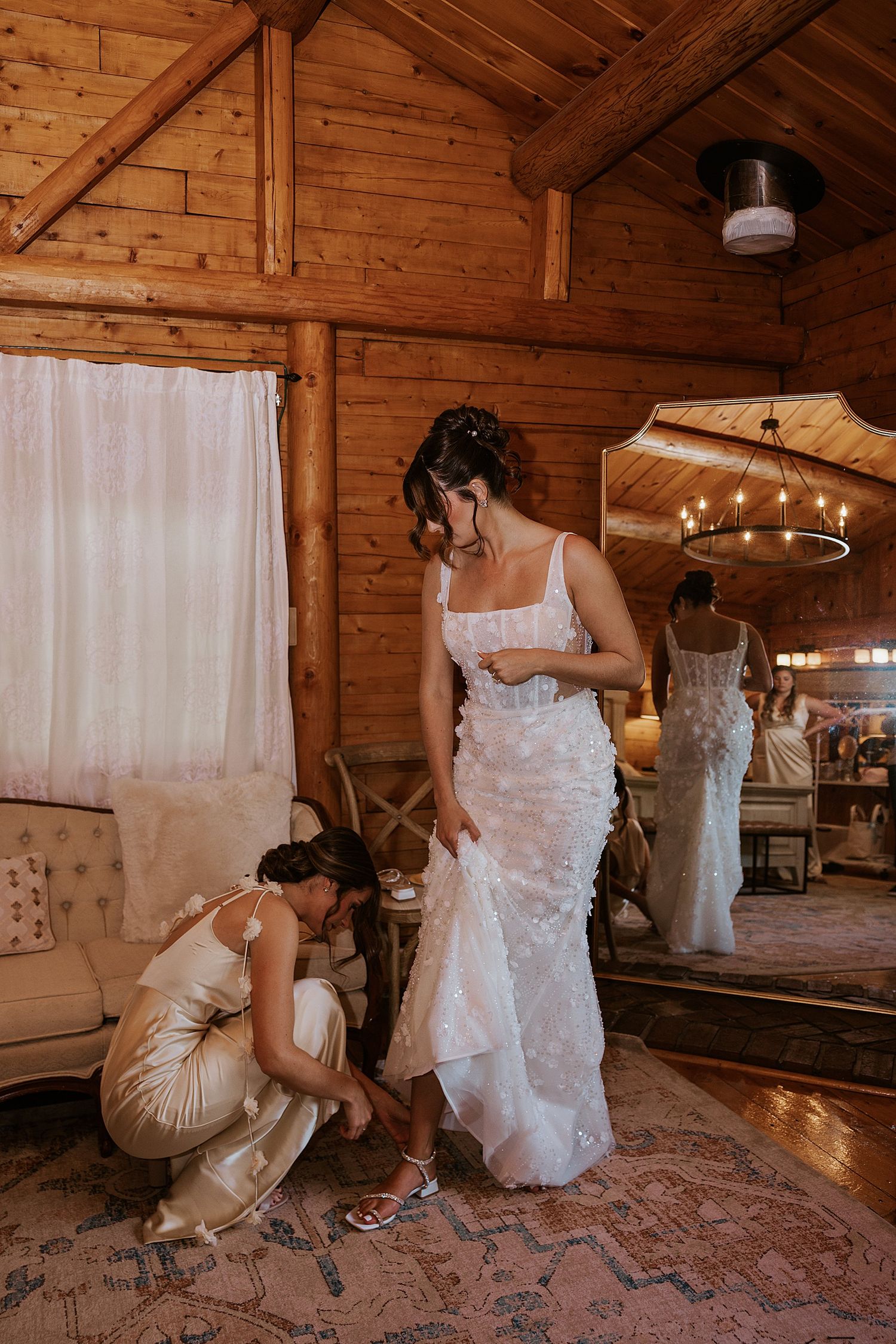 Bride getting help with her shoes on her New Hampshire wedding day