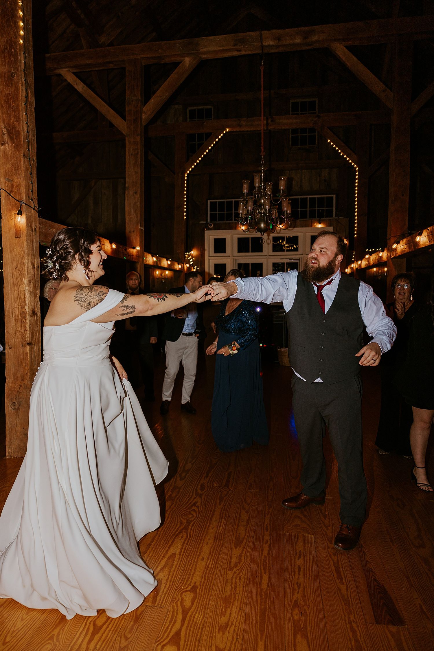 Bride and groom dancing with their guests at their New Hampshire wedding reception